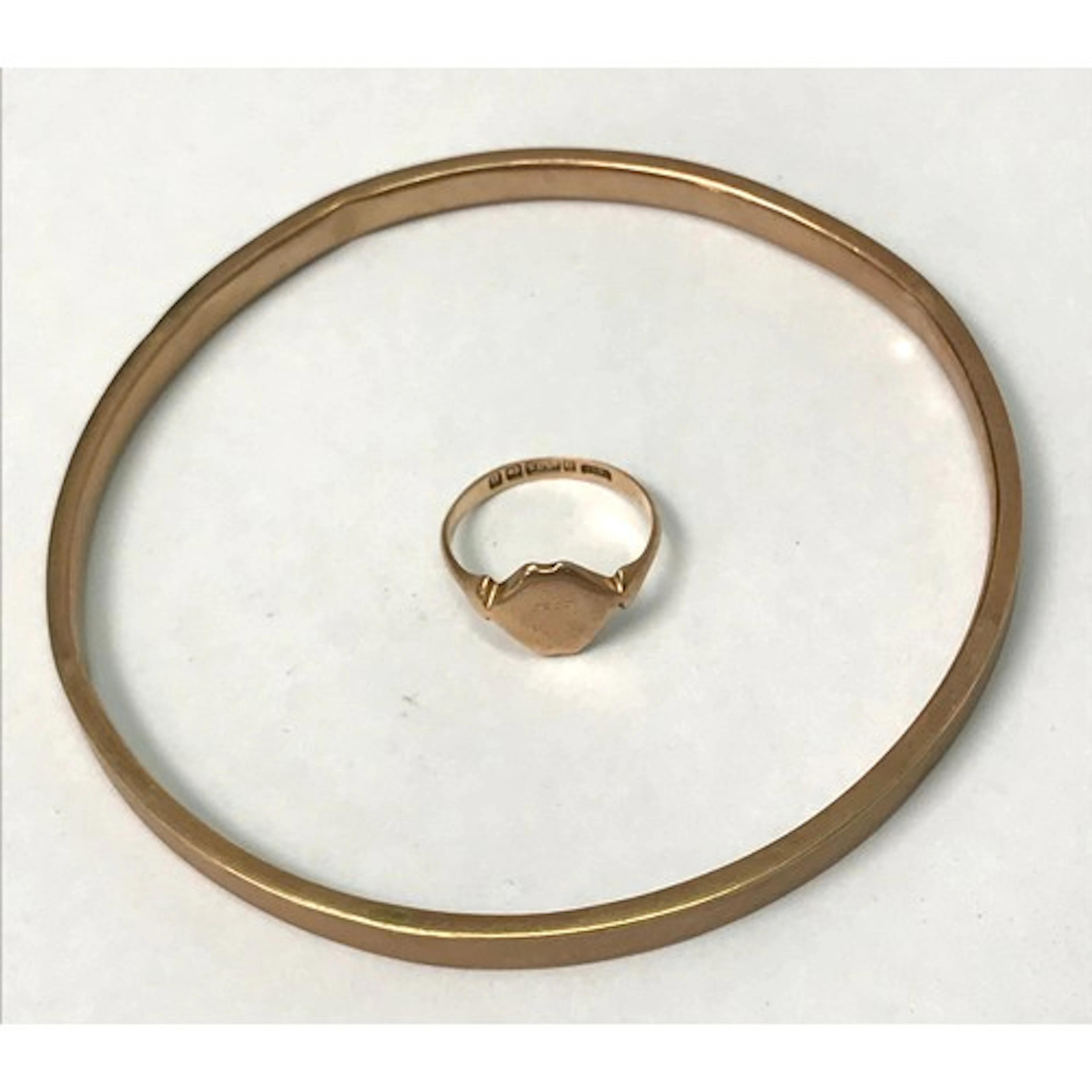 A 9ct gold hoop bangle, a/f dents etc; a 9ct gold signet rin...