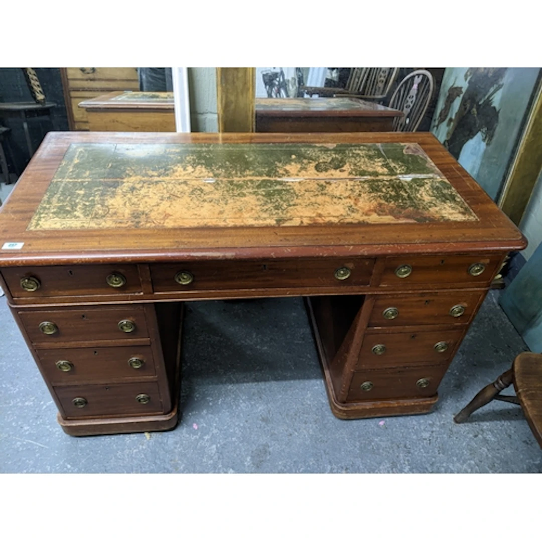 A late Victorian mahogany twin pedestal writing desk, the to...
