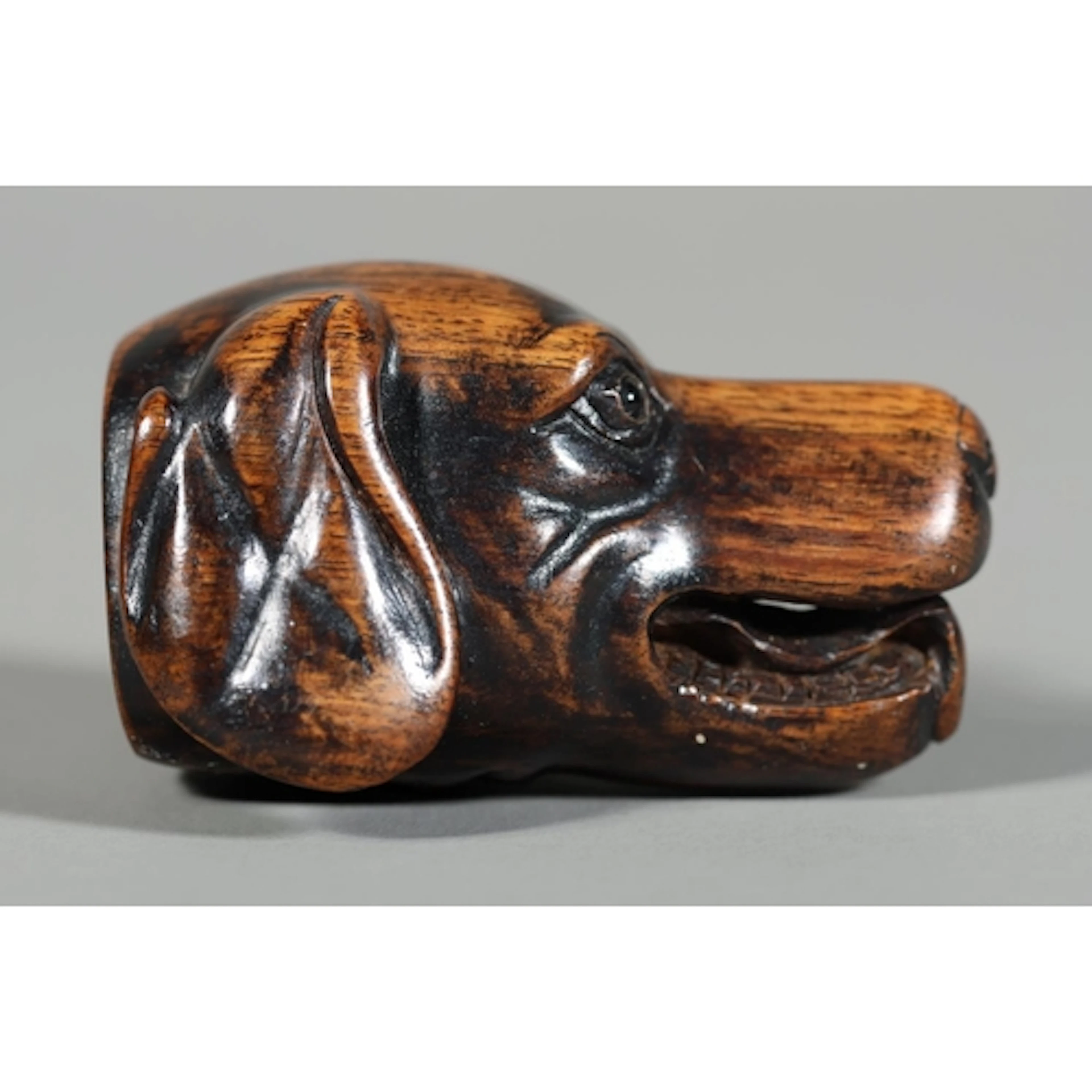 Antique Japanese carved wood netsuke in the form of a dogs h...
