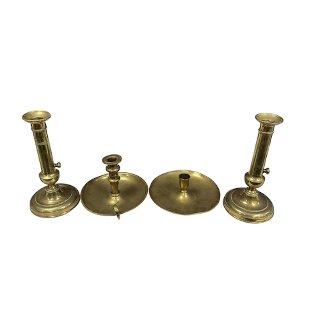 Four Georgian brass candle and chambersticks, three with tel...