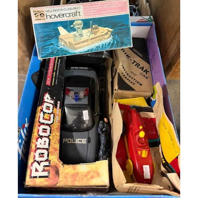 Box of assorted vintage toy vehicles to include: Robo Cop po...