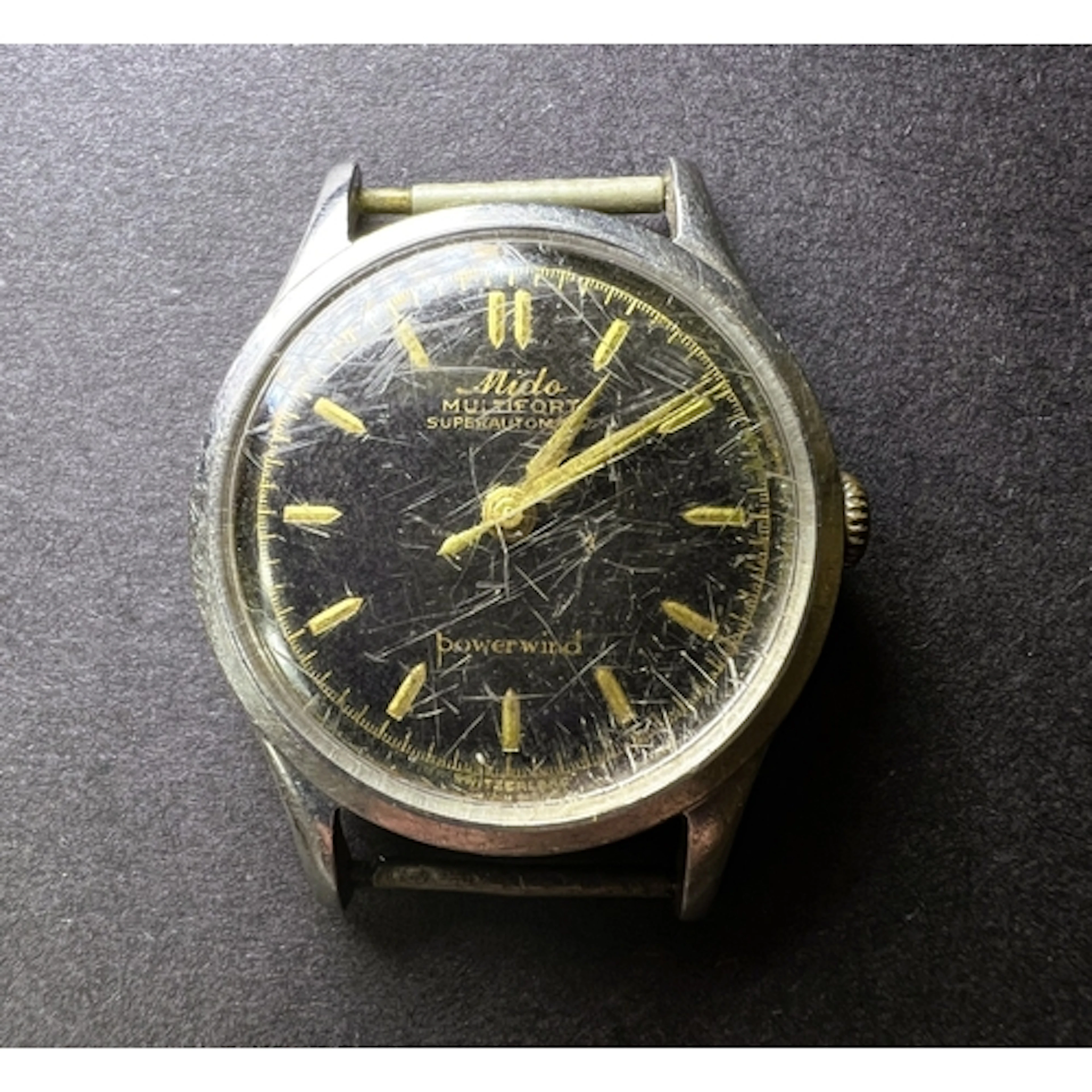 A vintage Mido black dial wrist watch with stanless steel ca...