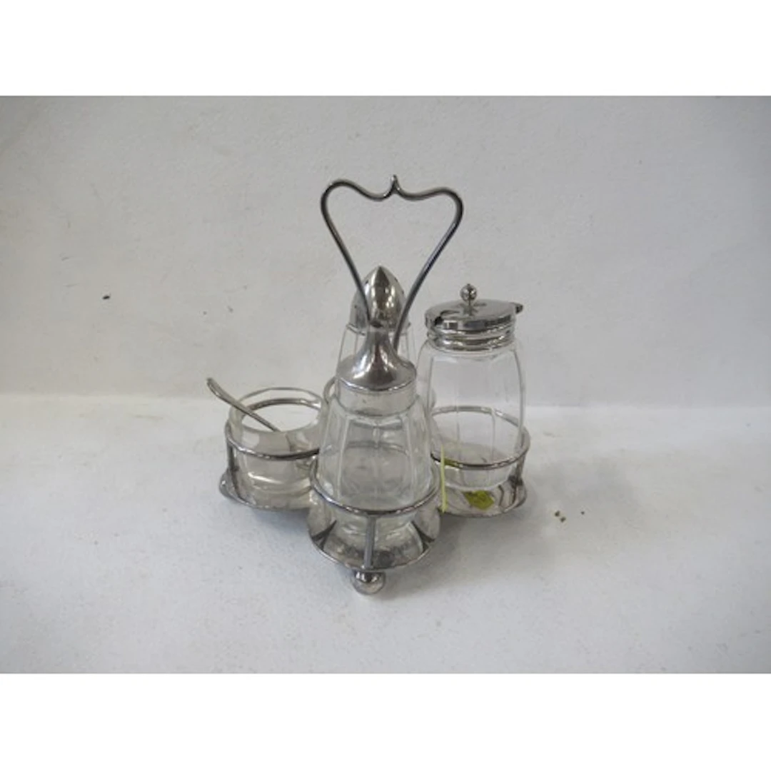A silver plated four piece cruet, with glass and silver plat...
