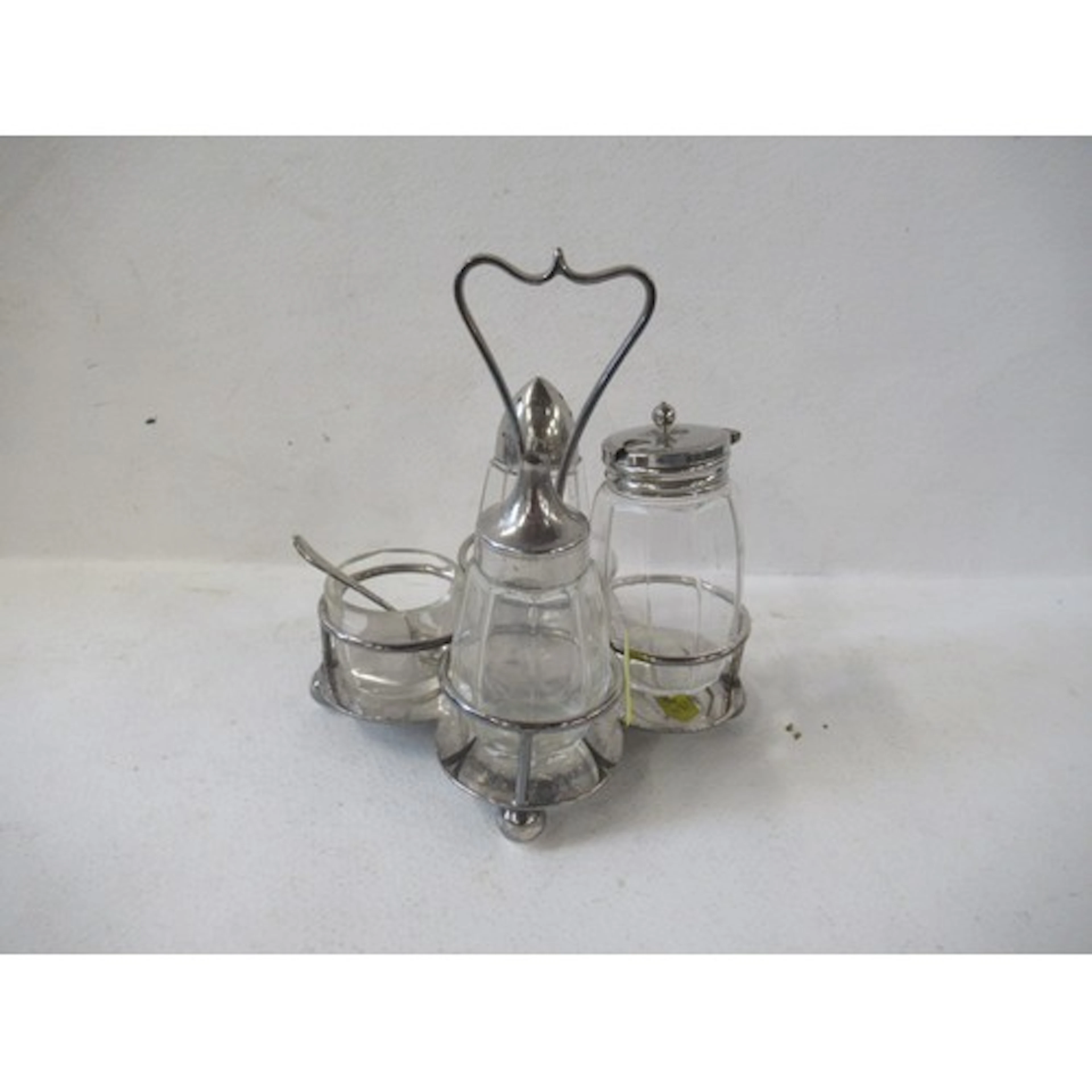 A silver plated four piece cruet, with glass and silver plat...