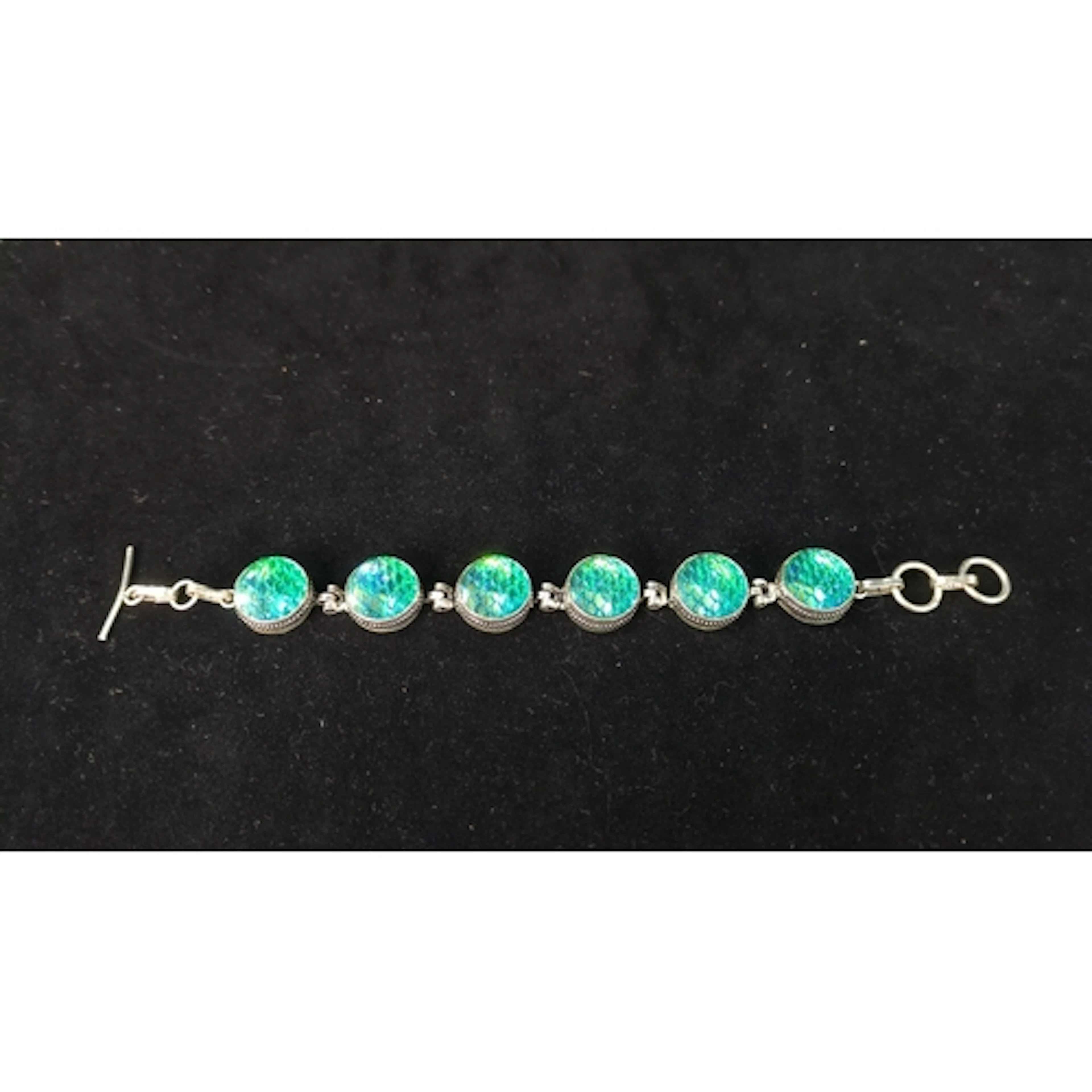 Sterling silver bracelet set with circular blue-green irides...