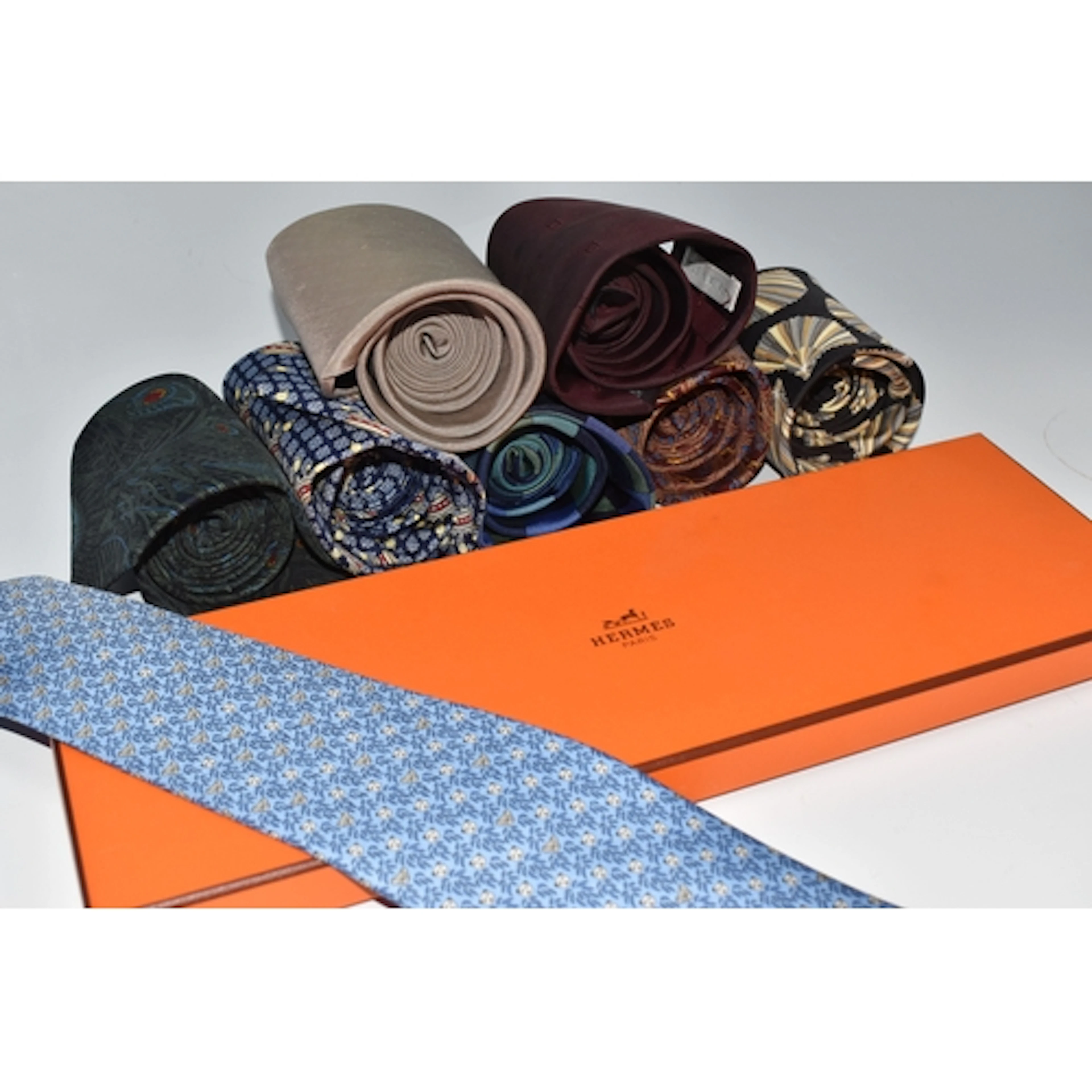 A BOX OF TIES, comprising a boxed pale blue Hermes tie, prin...