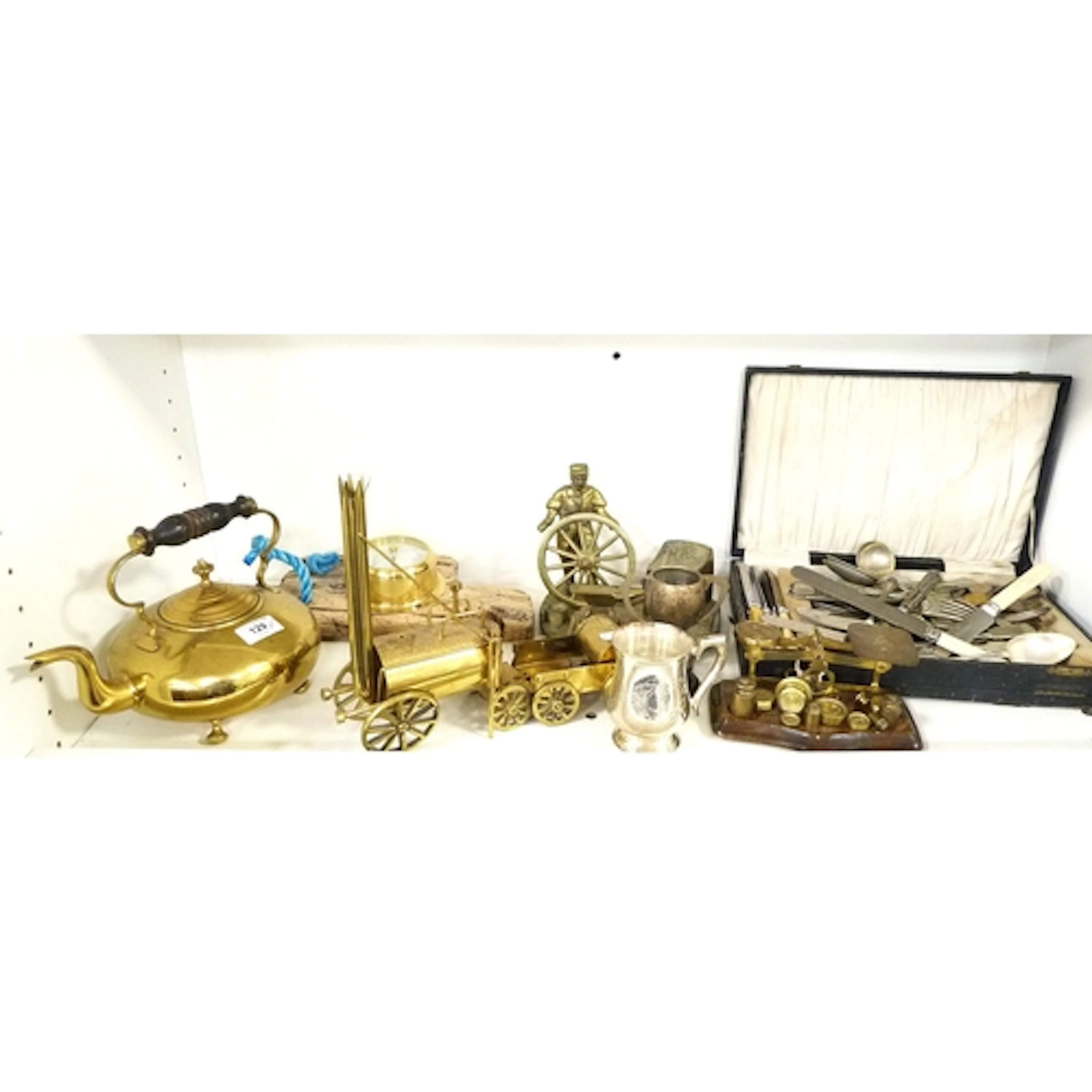 Shelf lot of brass to include toddy kettle, figure group of ...