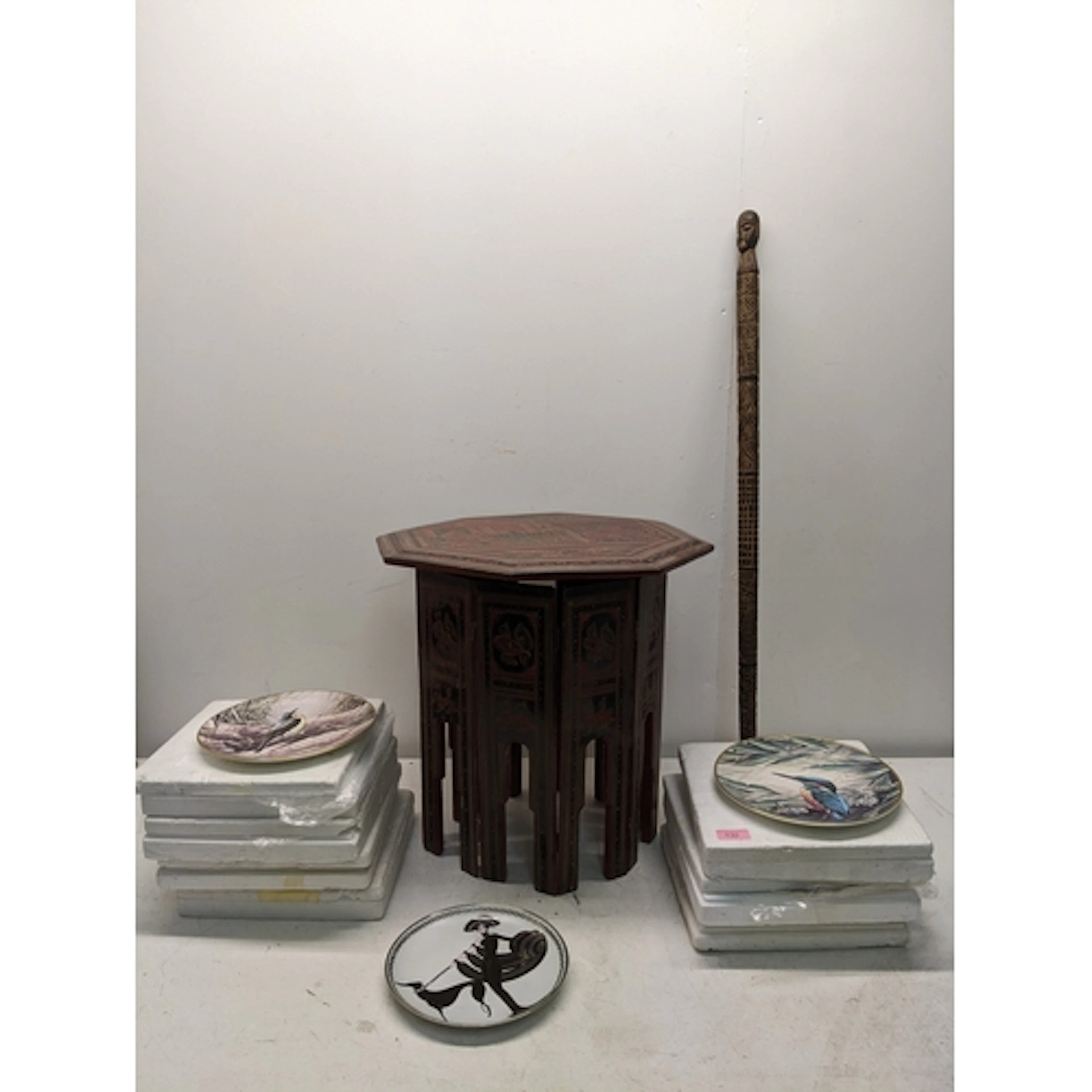 A Burmese folding octagonal occasional table, a wooden Afric...