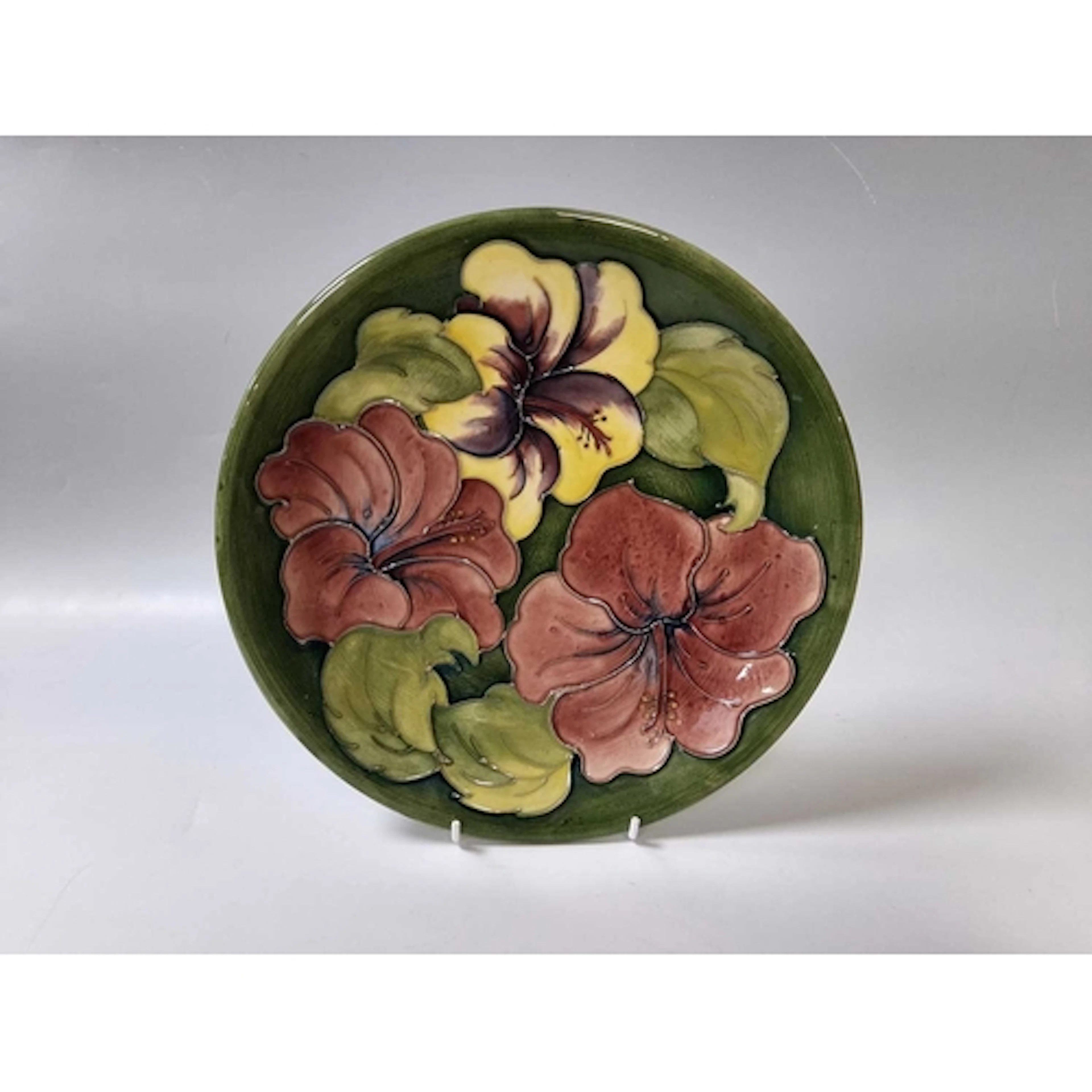 TWO PIECES OF MOORCROFT POTTERY comprising a mid-century pla...