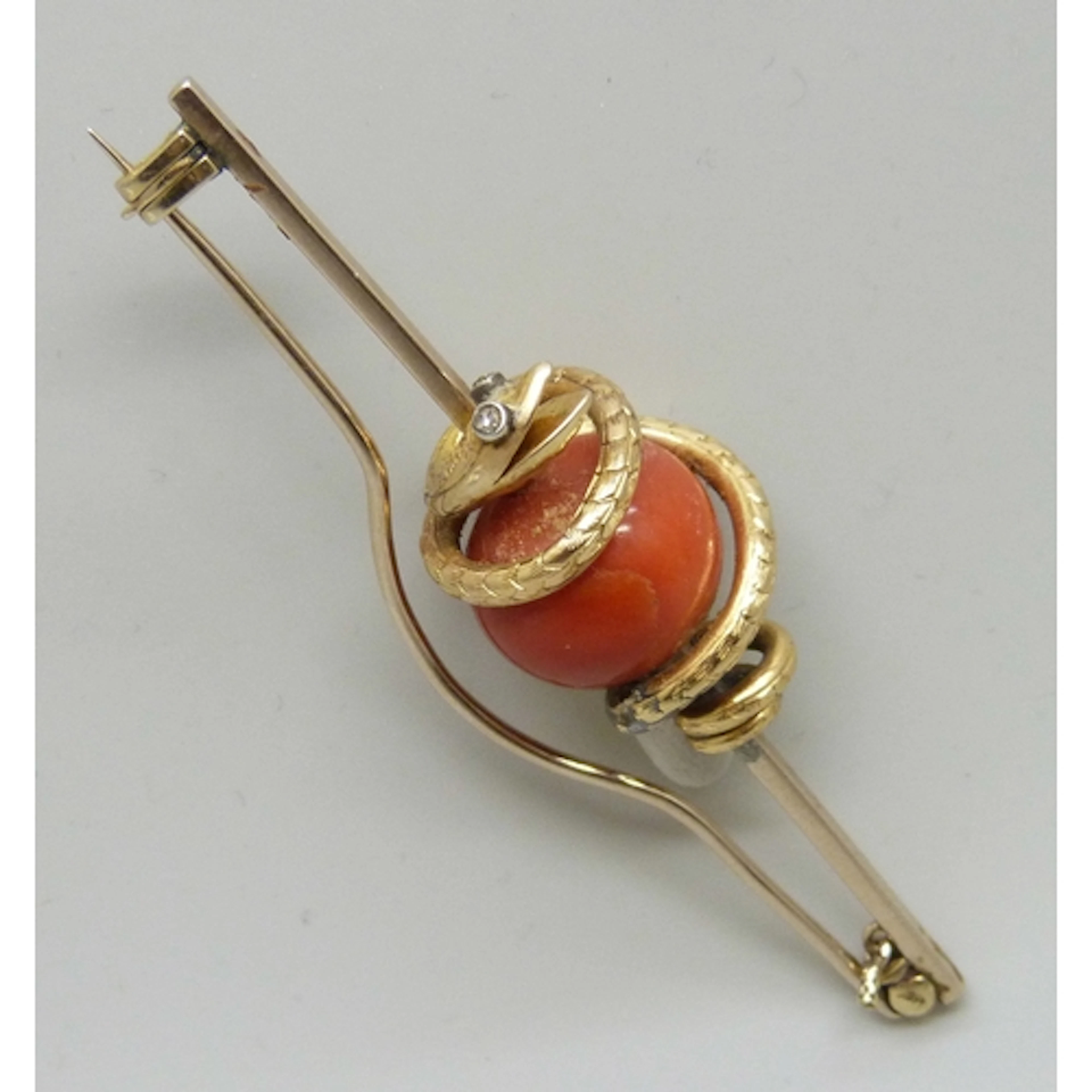 A Victorian yellow metal snake design brooch, the serpent se...