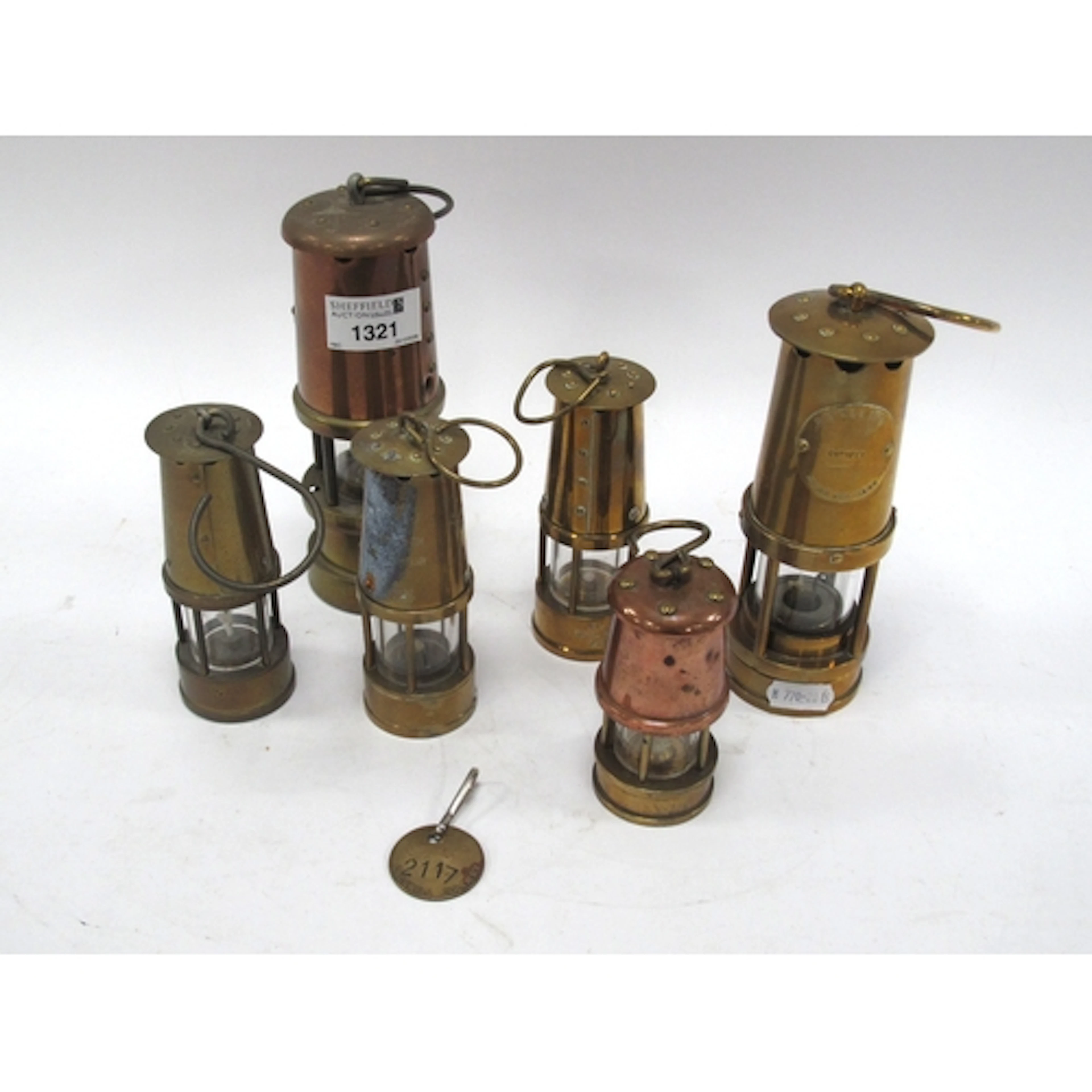 Six miniature brass and copper miner's safety lamps, includi...