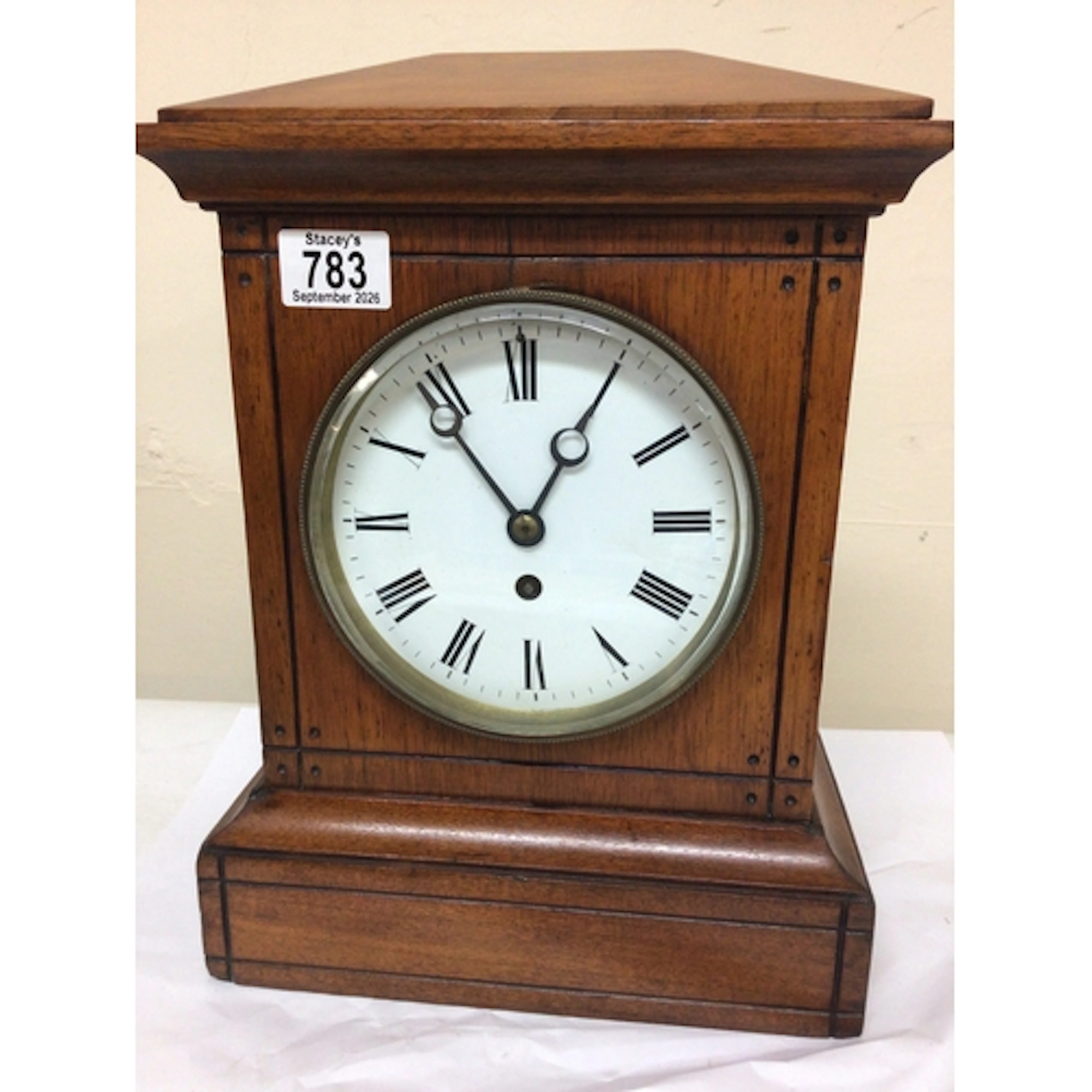 A Victorian mantel clock with a walnut case and enamel dial ...