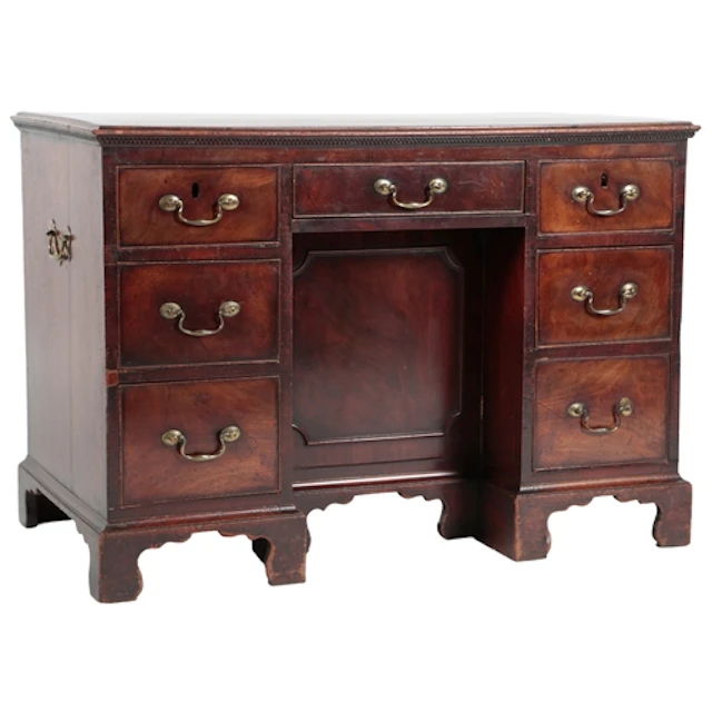 A George III mahogany kneehole desk, the crossbanded top ove...