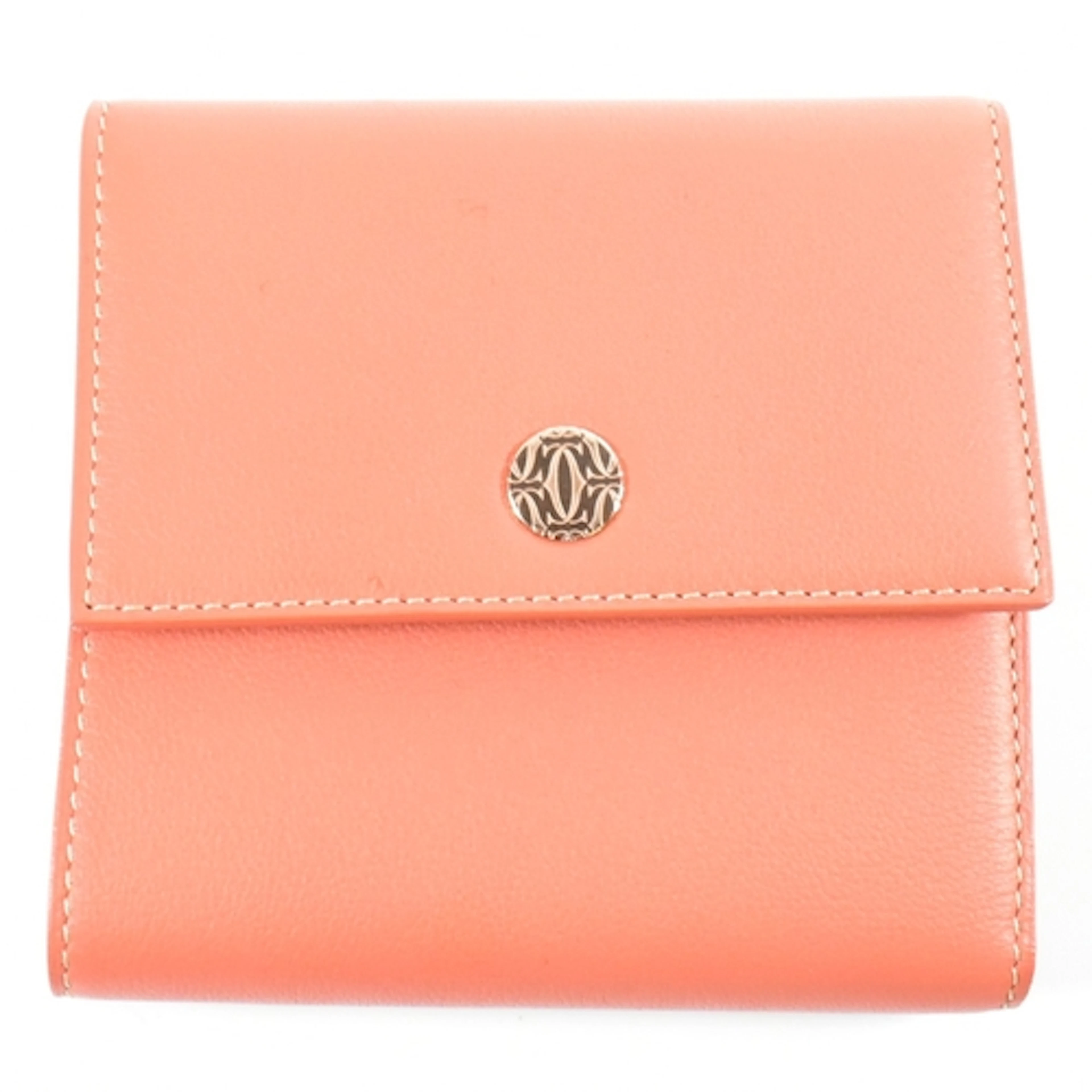 A Cartier coral leather purse. The Cartier purse having a fu...