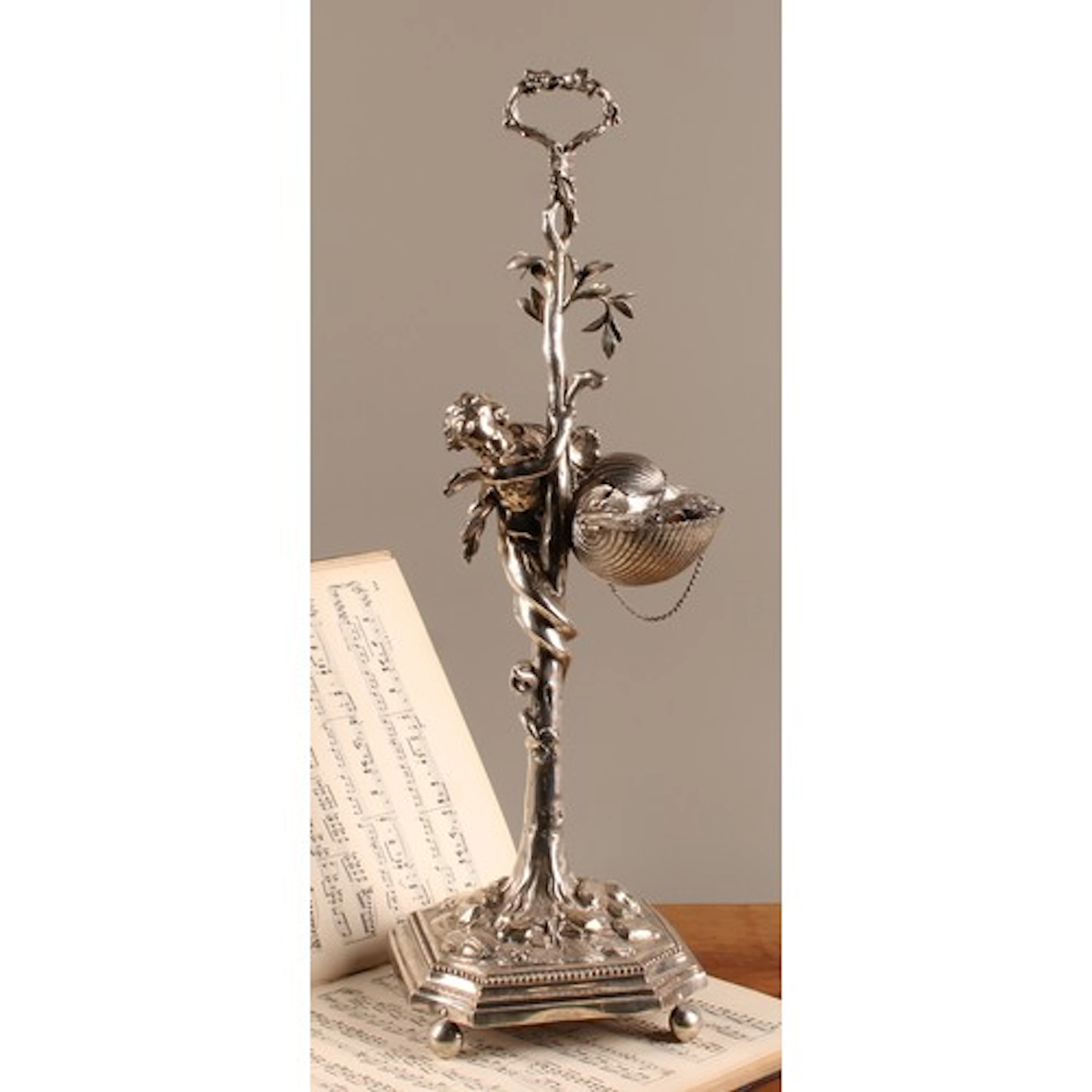 An Italian Baroque silver table spout lamp, as a scantily cl...