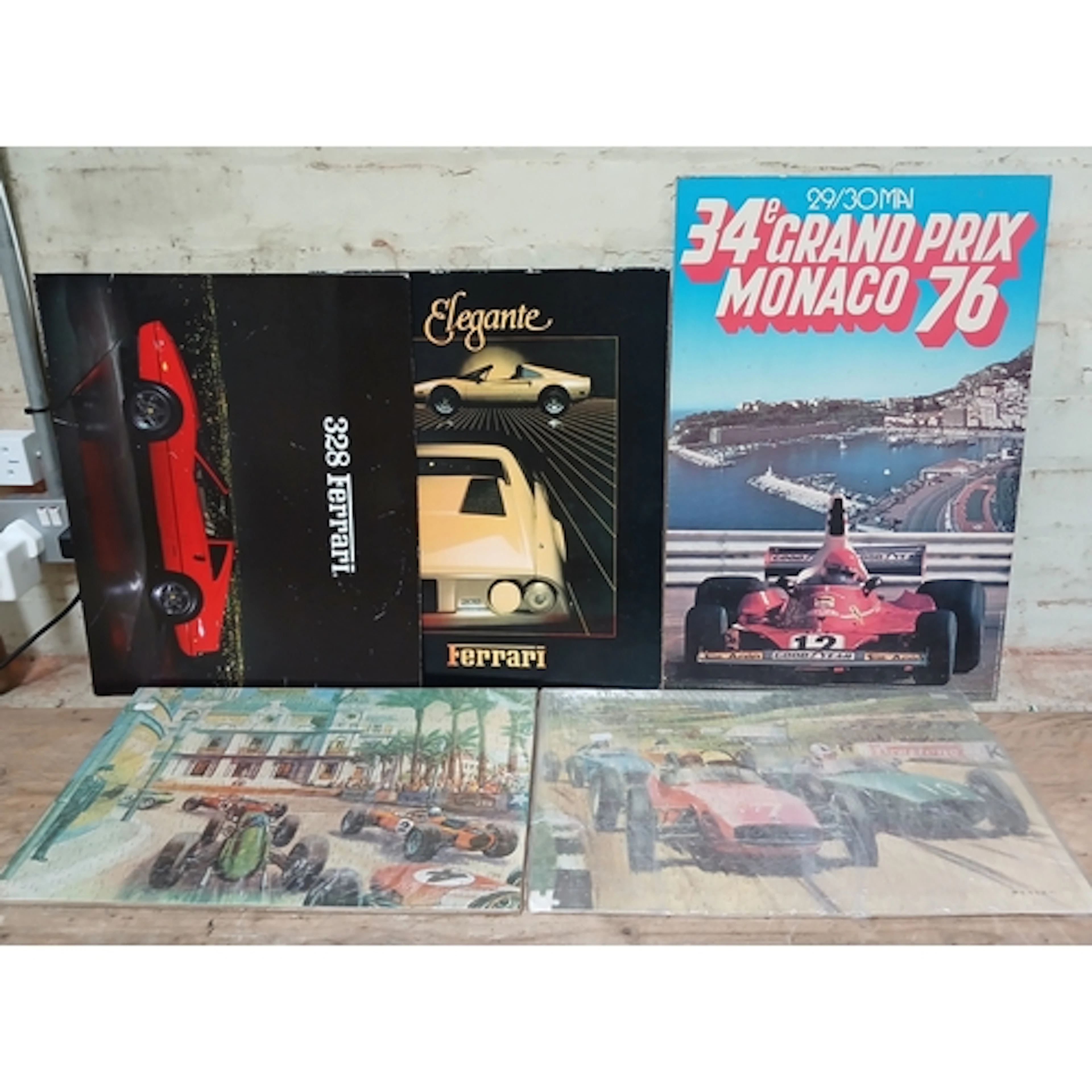 Three car prints on board and two vintage motor racing jigsa...