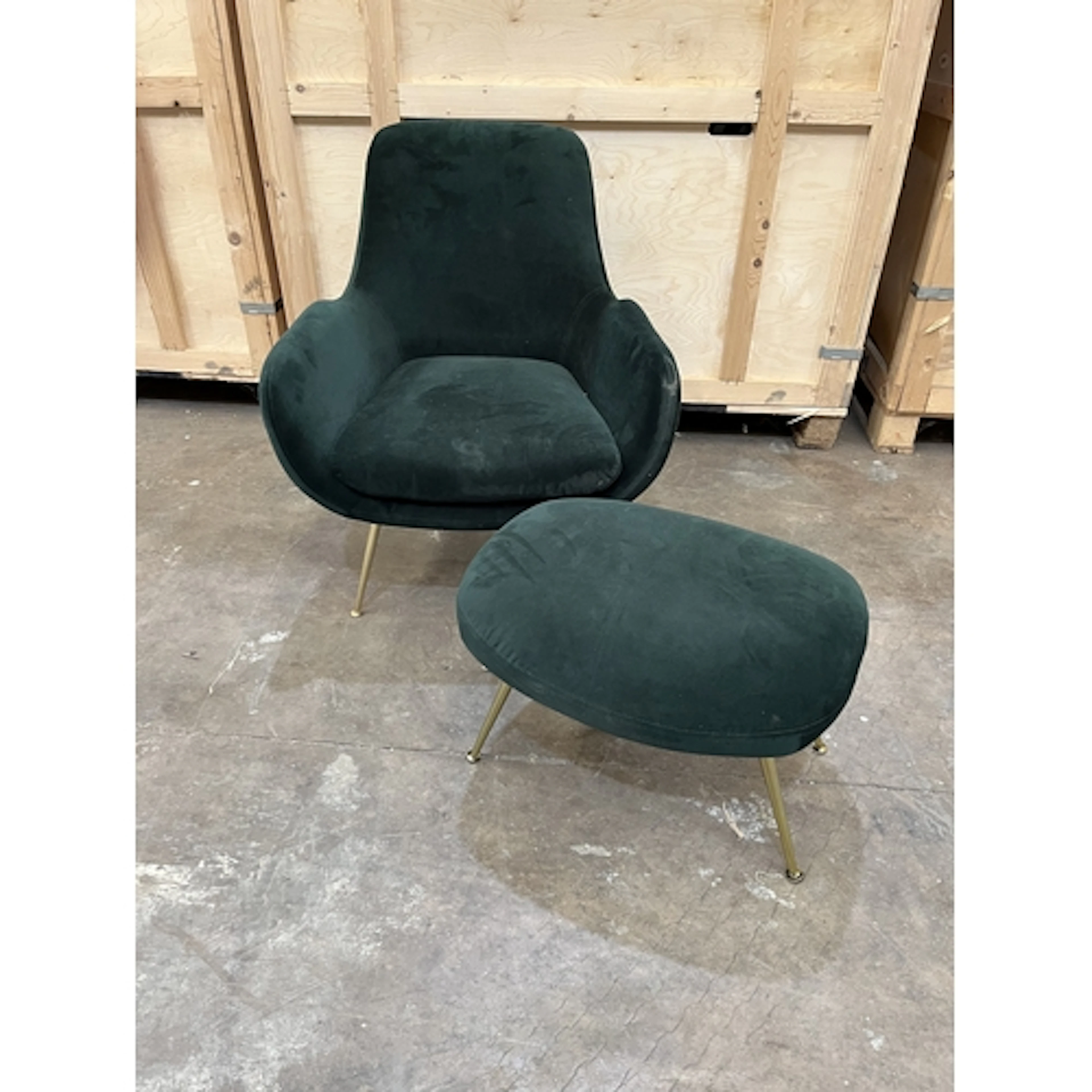 AN EMERALD GREEN FABRIC ARMCHAIR, on gold coloured metal leg...