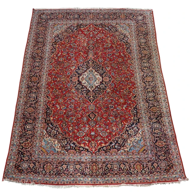 KASHAN CARPET, CENTRAL PERSIA, CIRCA 1970. The raspberry fie...