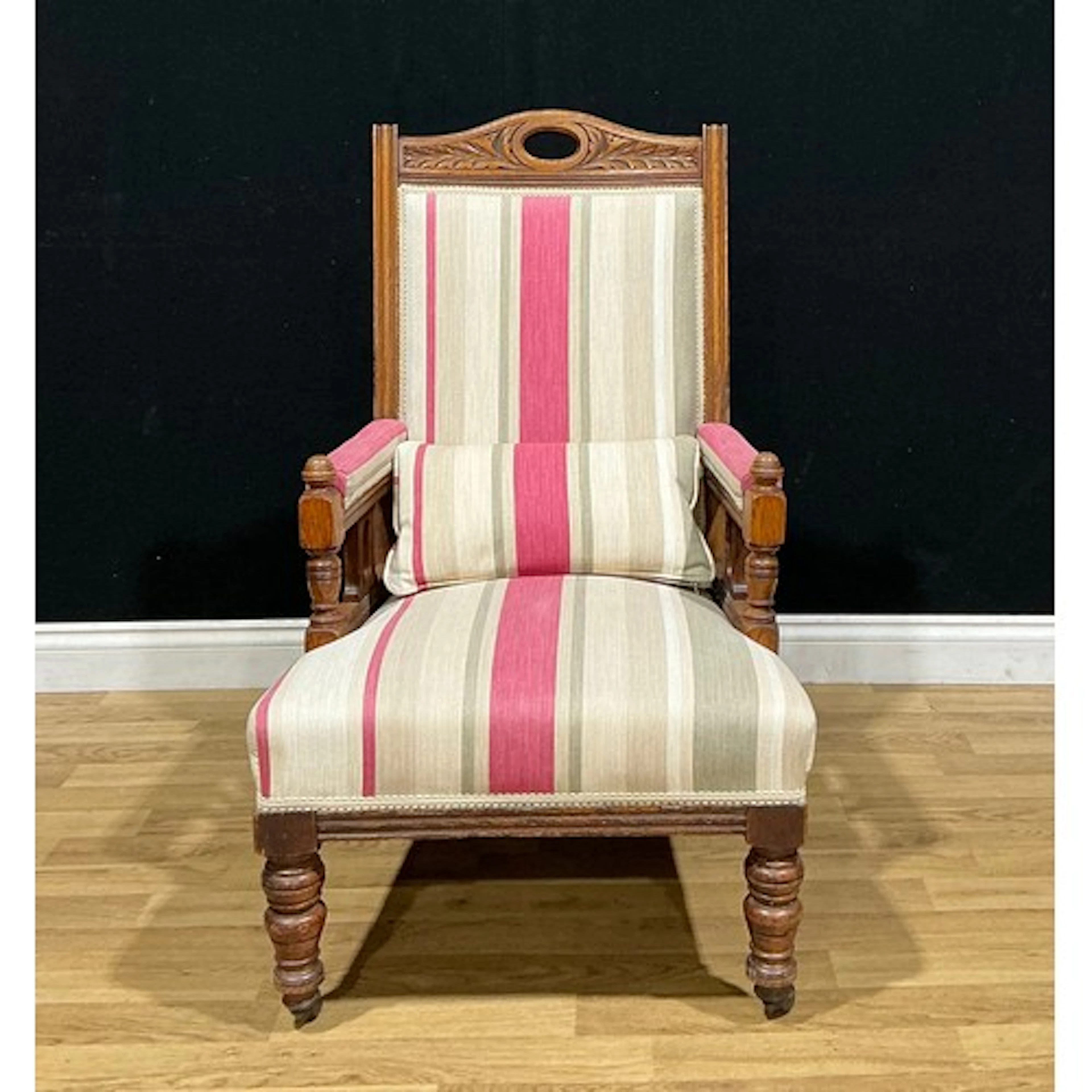 A late Victorian oak drawing room chair, in the Eastlake man...