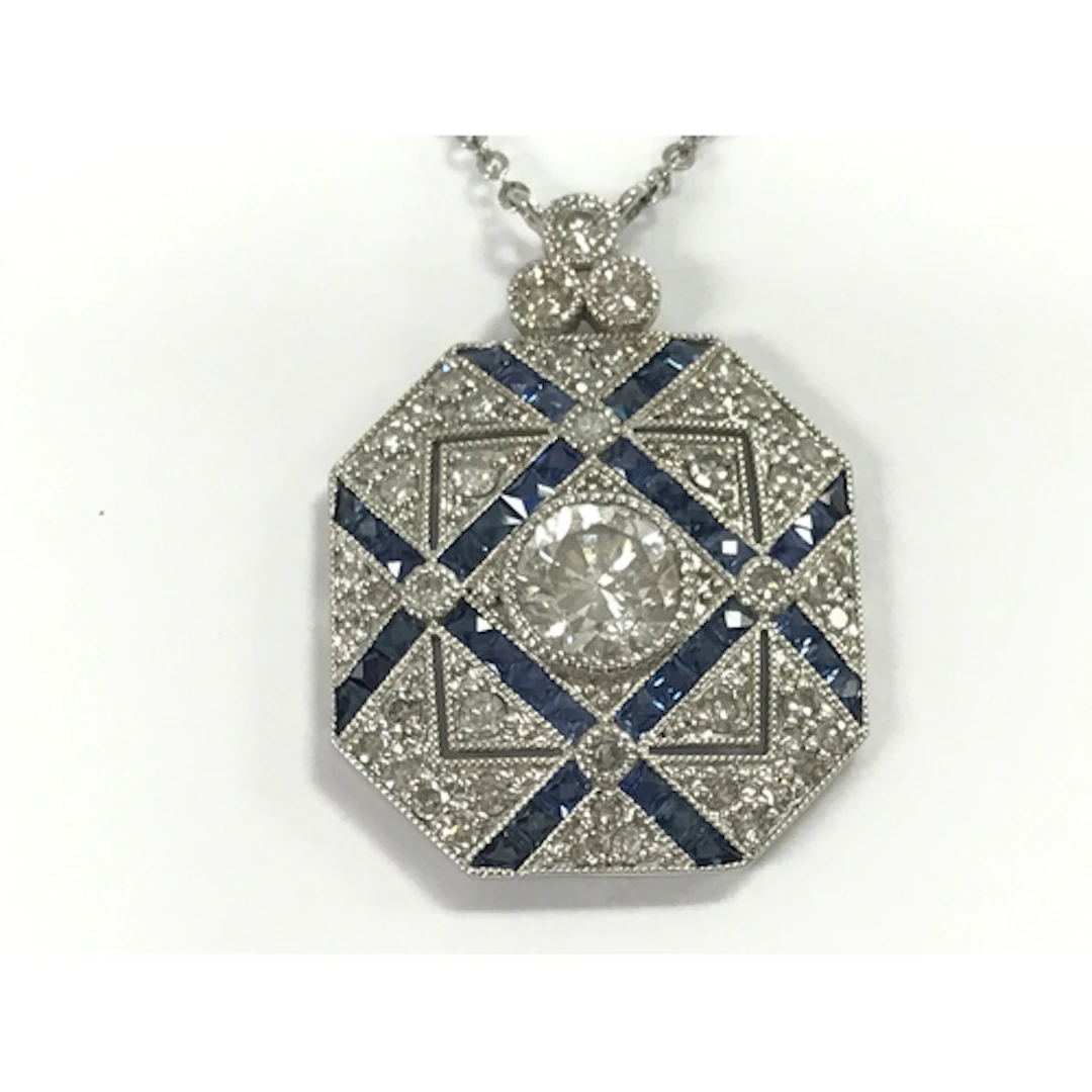 Platinum panel style pendant set with diamonds and sapphires...