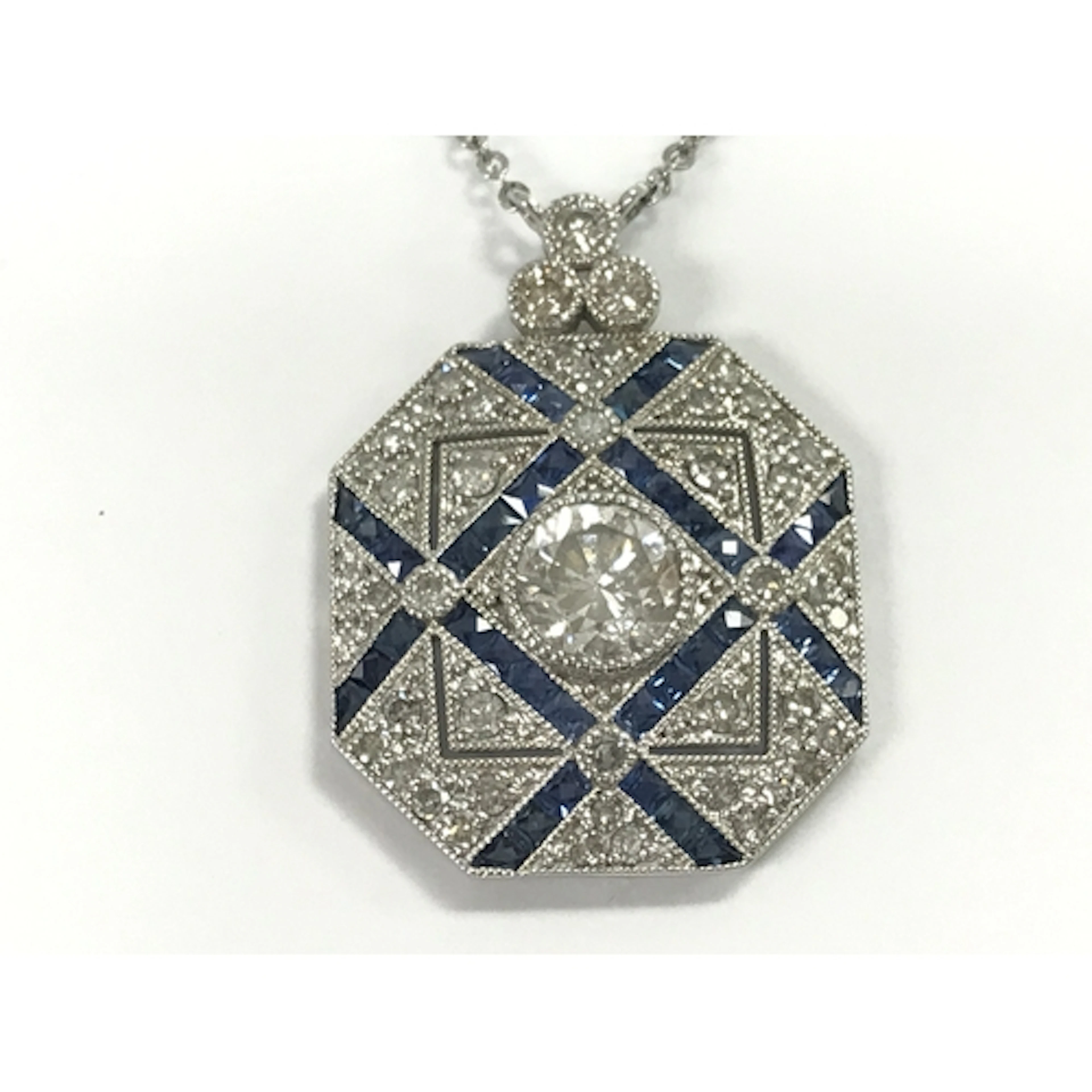 Platinum panel style pendant set with diamonds and sapphires...