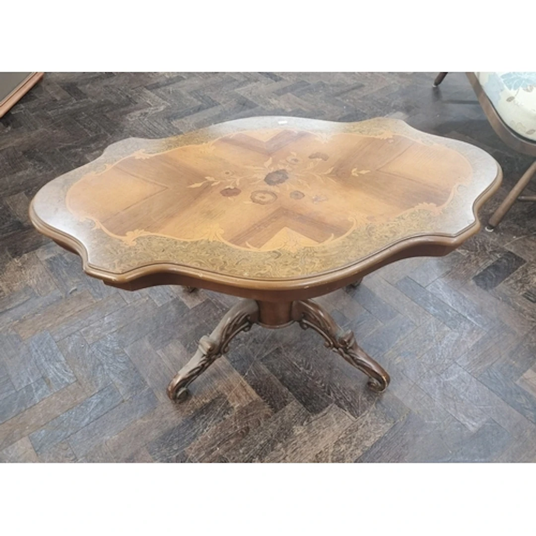 An Italian style floral inlaid shaped topped coffee table on...