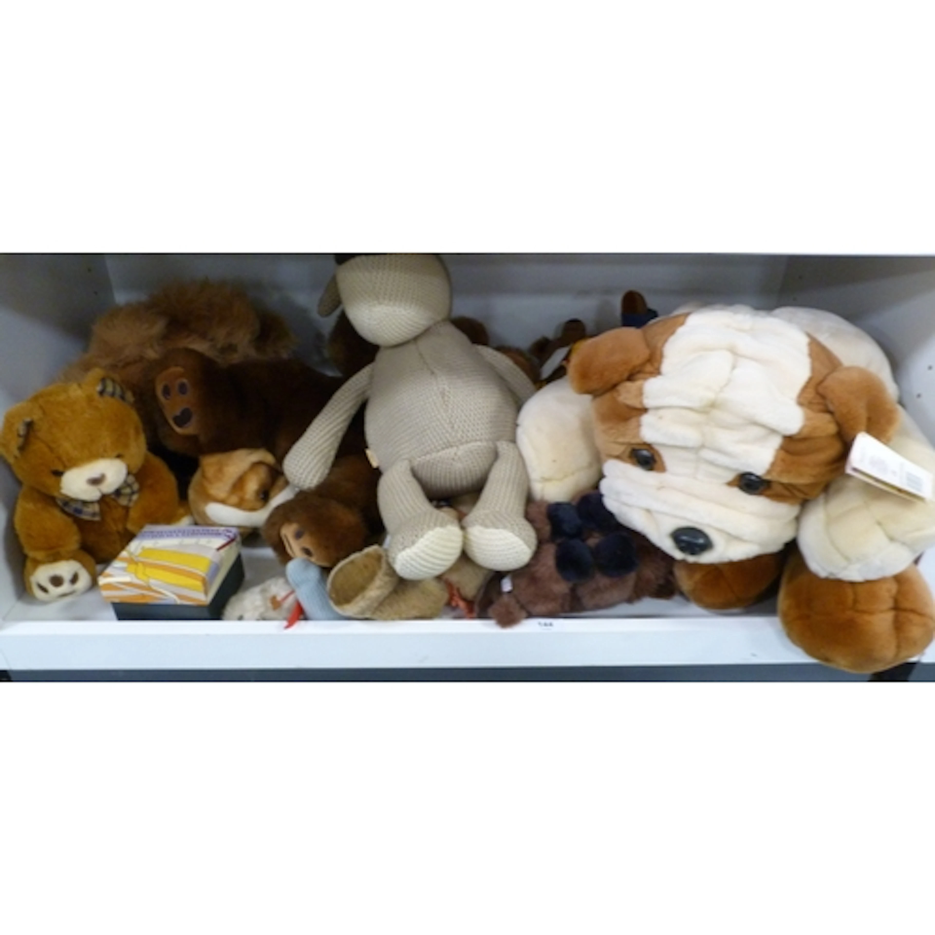 Shelf of teddy bears and soft toys to include dogs and Harri...