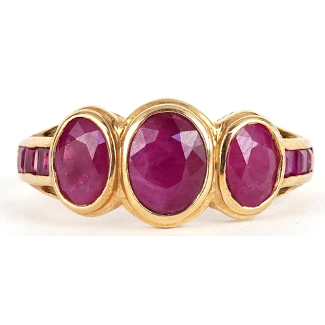 9ct gold ruby trilogy ring set with rubies to the shoulders,...