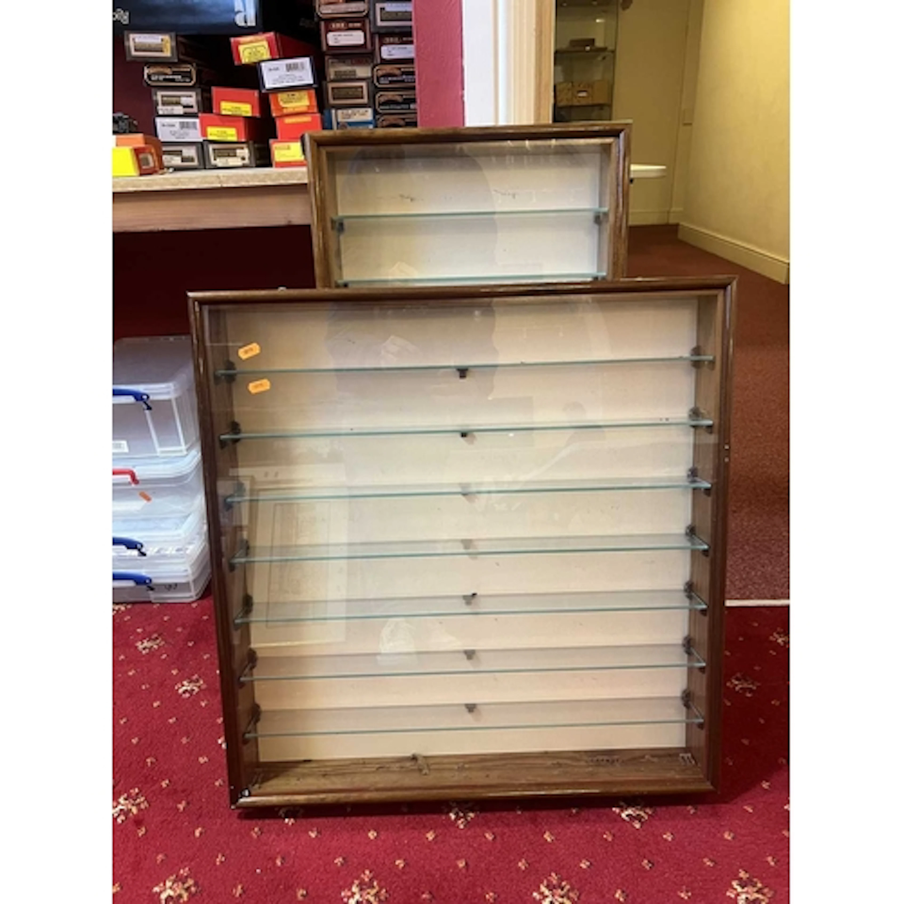 TWO WALL MOUNTED DISPLAY CASES, wooden units with glass fron...
