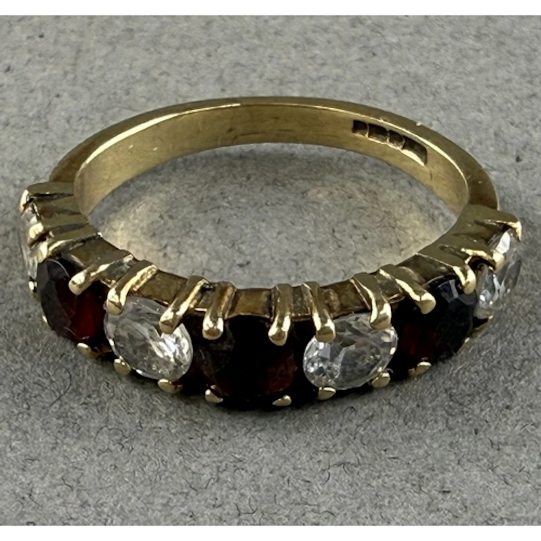 Jewellery: a 9ct gold and paste ring, set a run of seven alt...