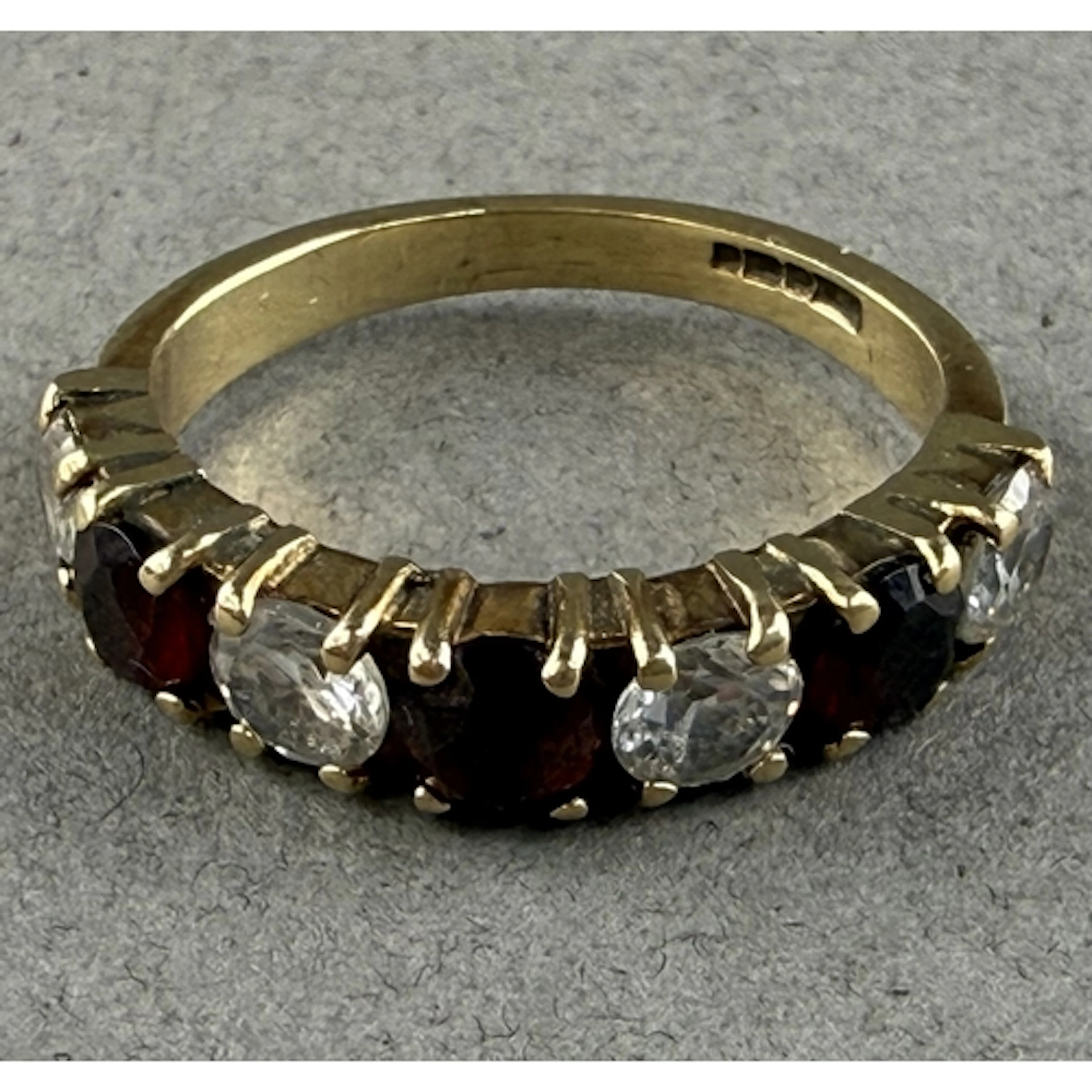Jewellery: a 9ct gold and paste ring, set a run of seven alt...
