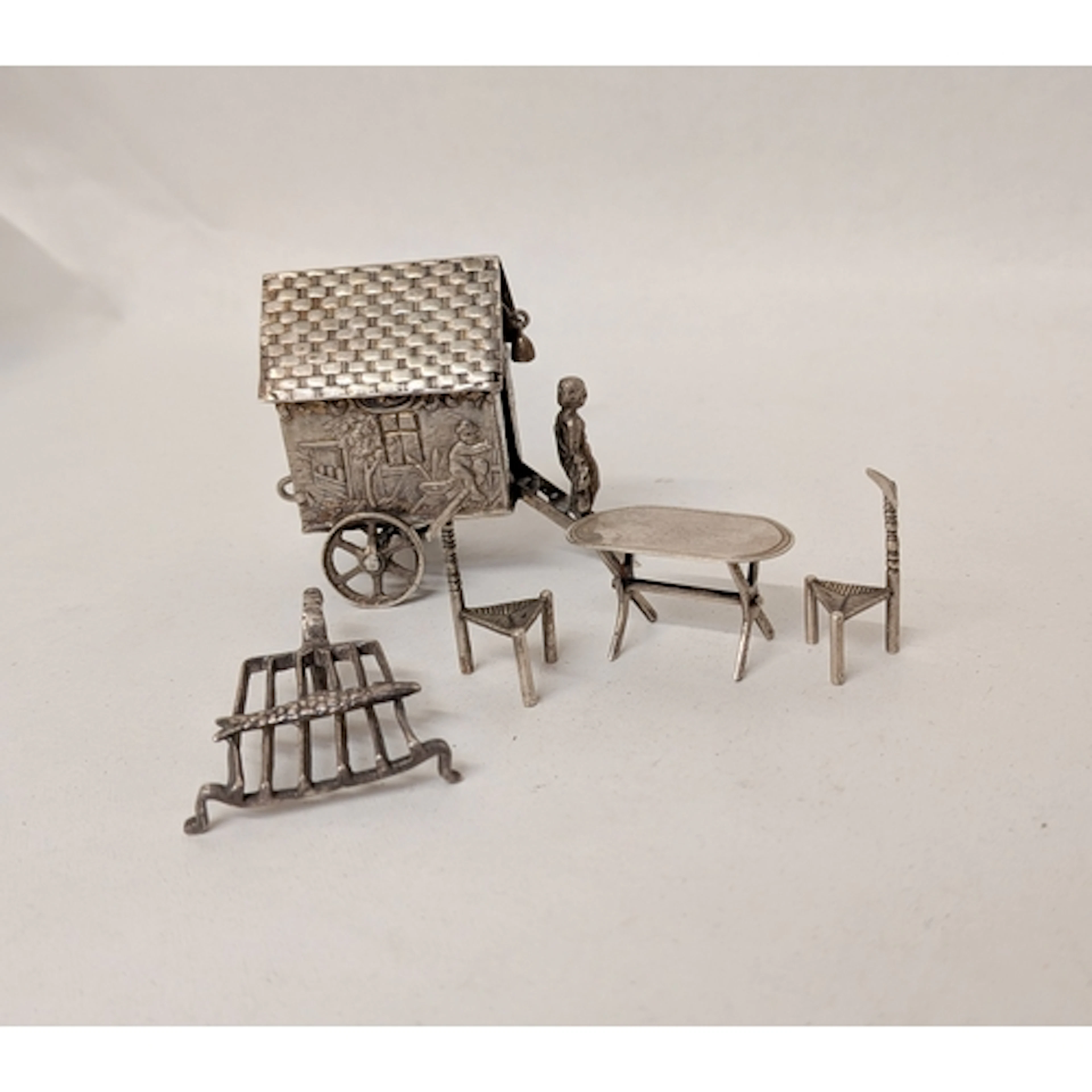 Silver novelties - a bathing hut, fish on a barbecue grill, ...