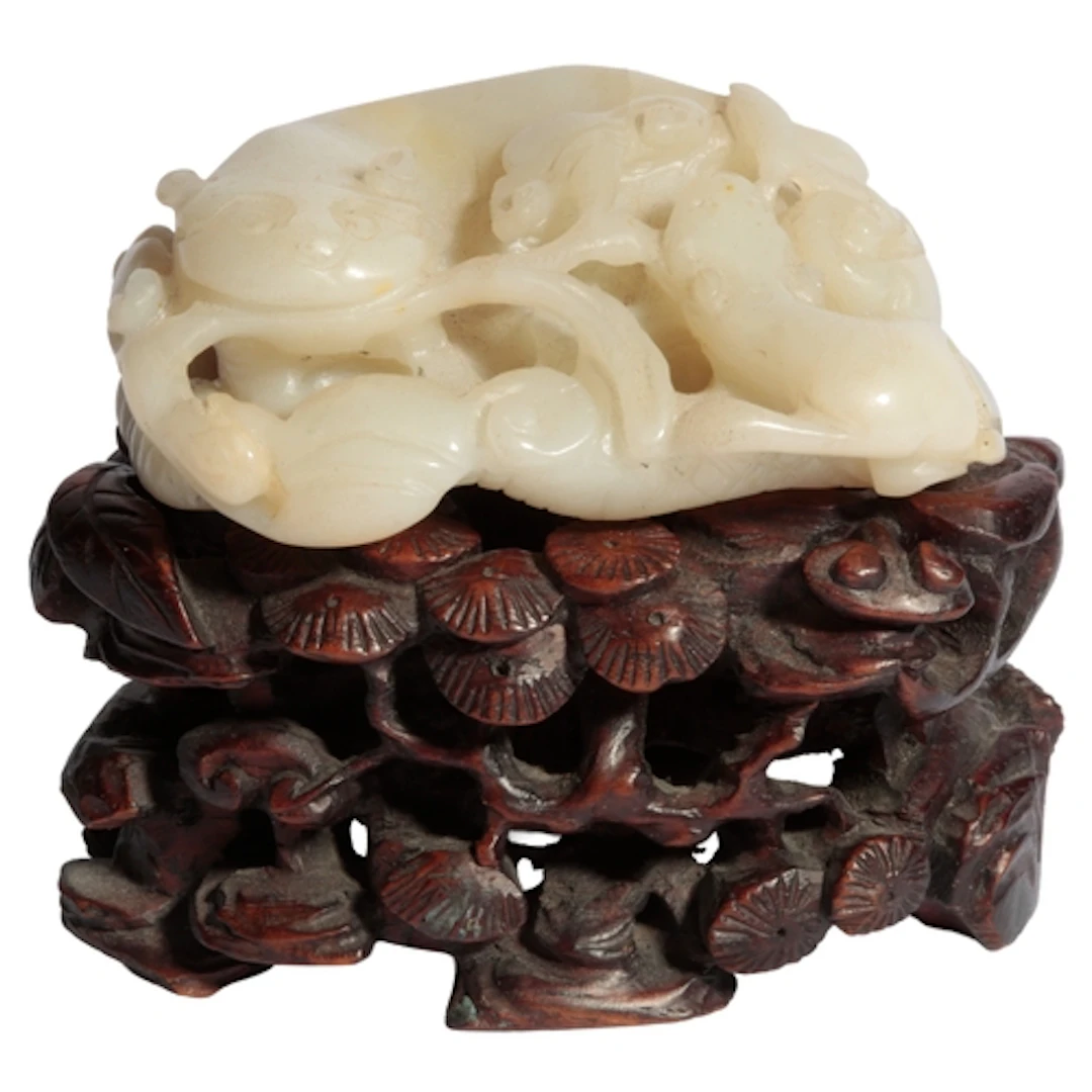 A Chinese creamy jade lion-dog group, 19th century, the lion...