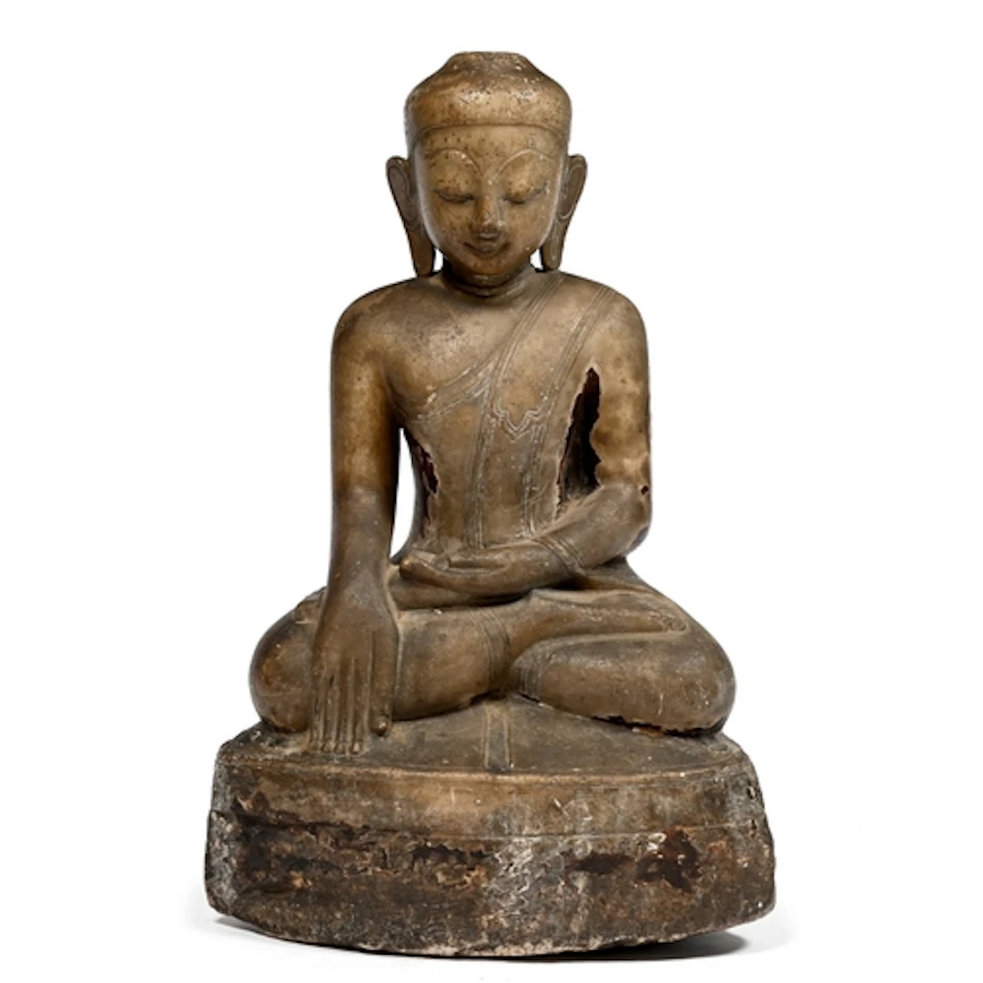 A Thai carved and glazed stone statue of a seated Buddha, Ay...