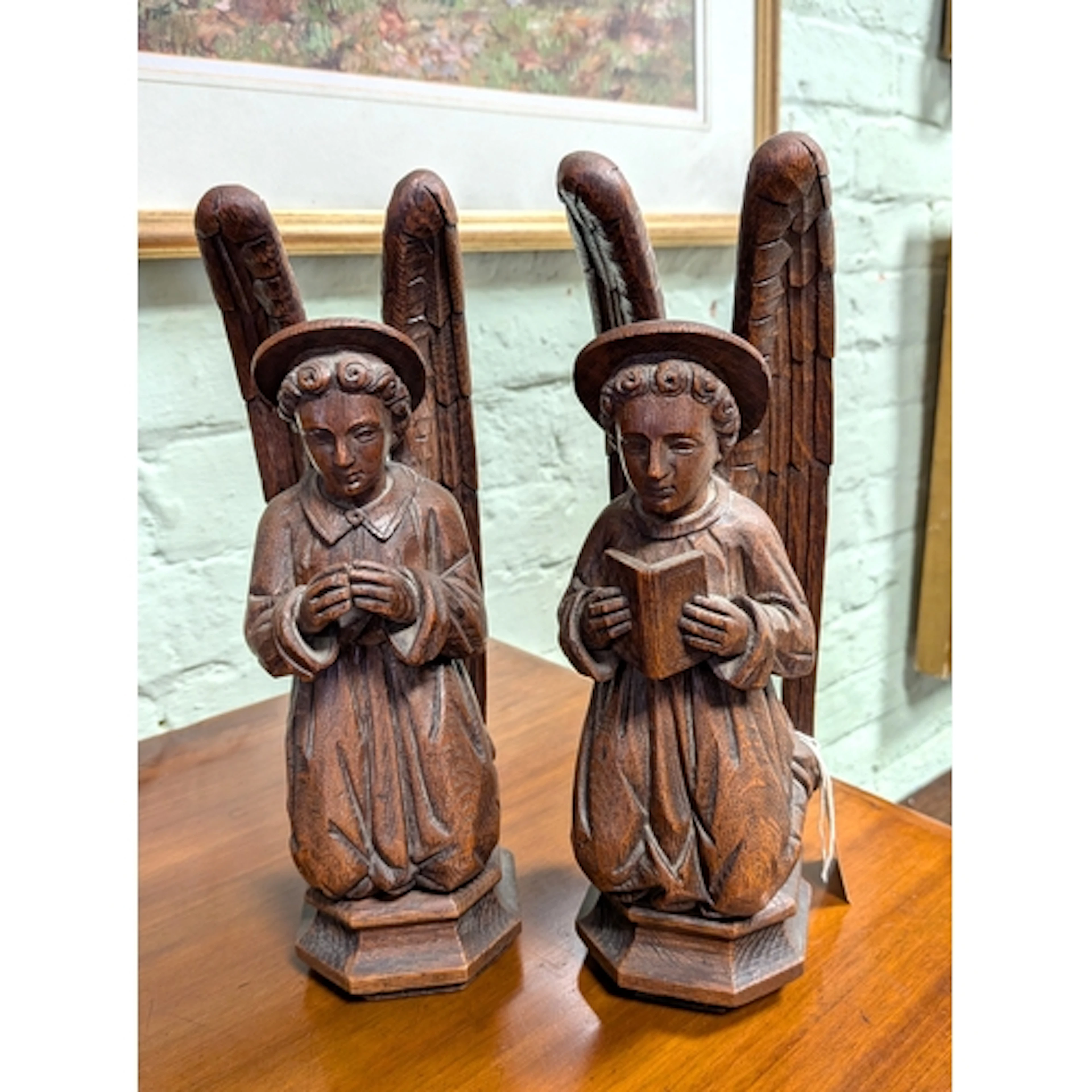 A pair of antique French carved oak kneeling and praying ang...