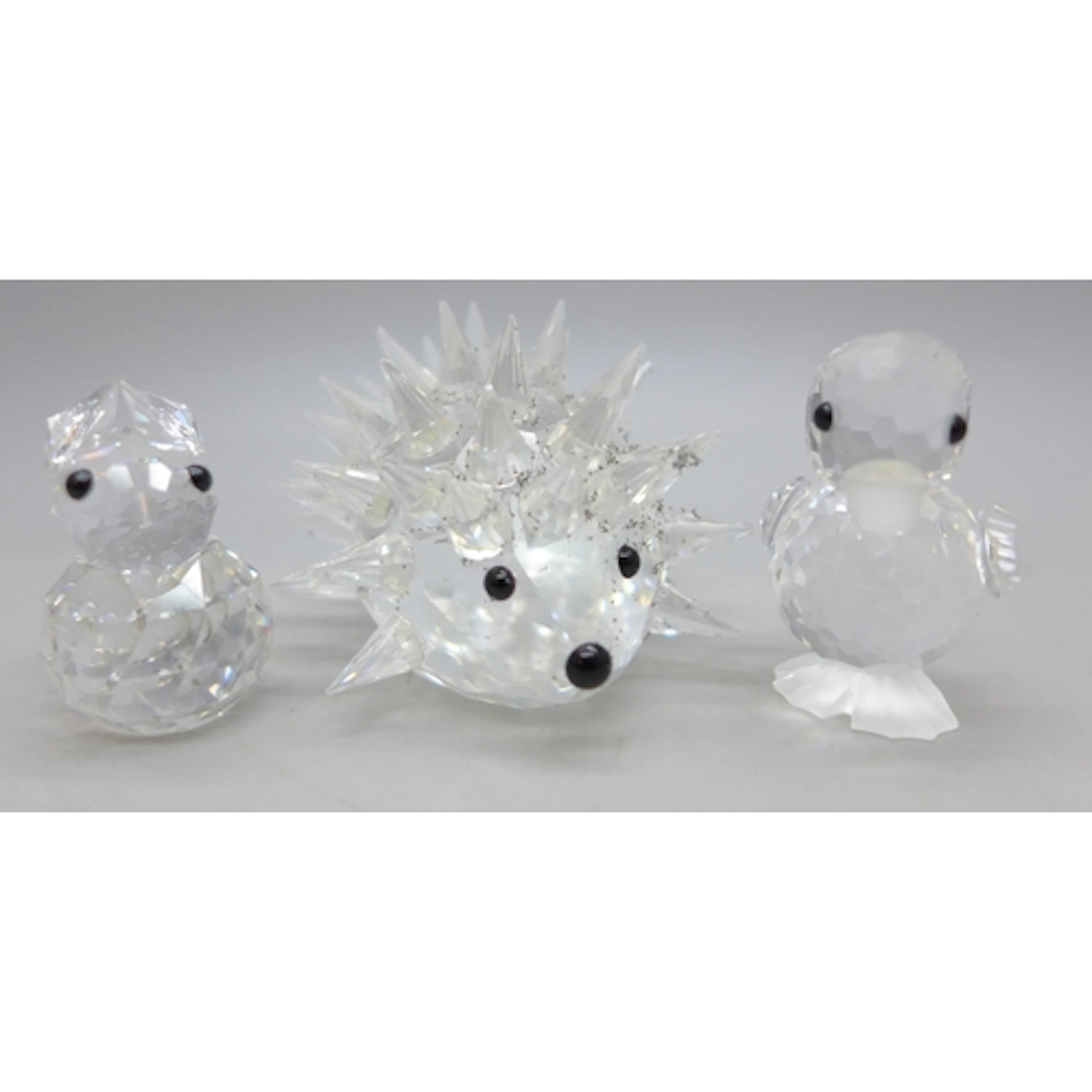 Three small Swarovski crystal figures, hedgehog, chick and r...
