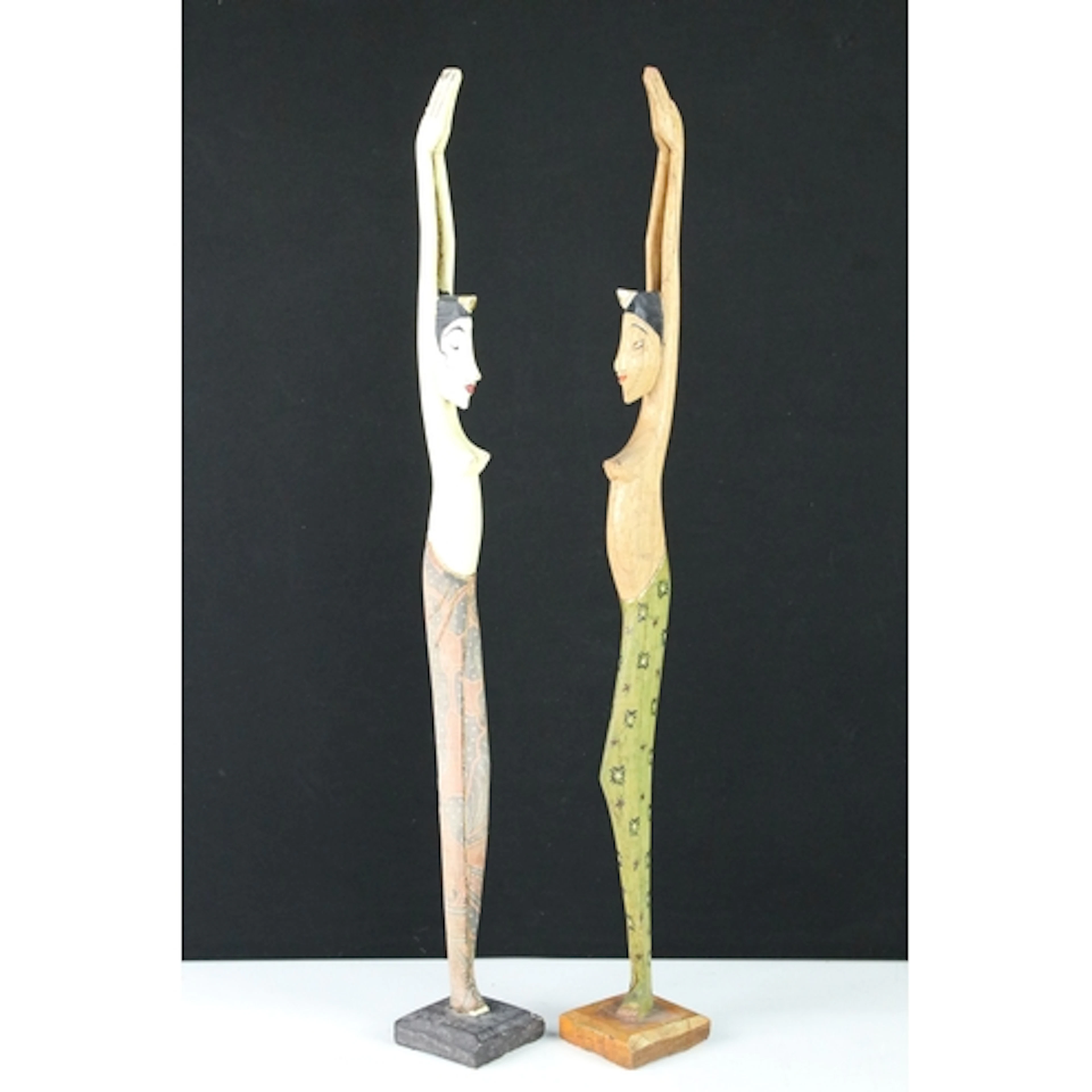 Two 20th century carved wooden figures of slender proportion...