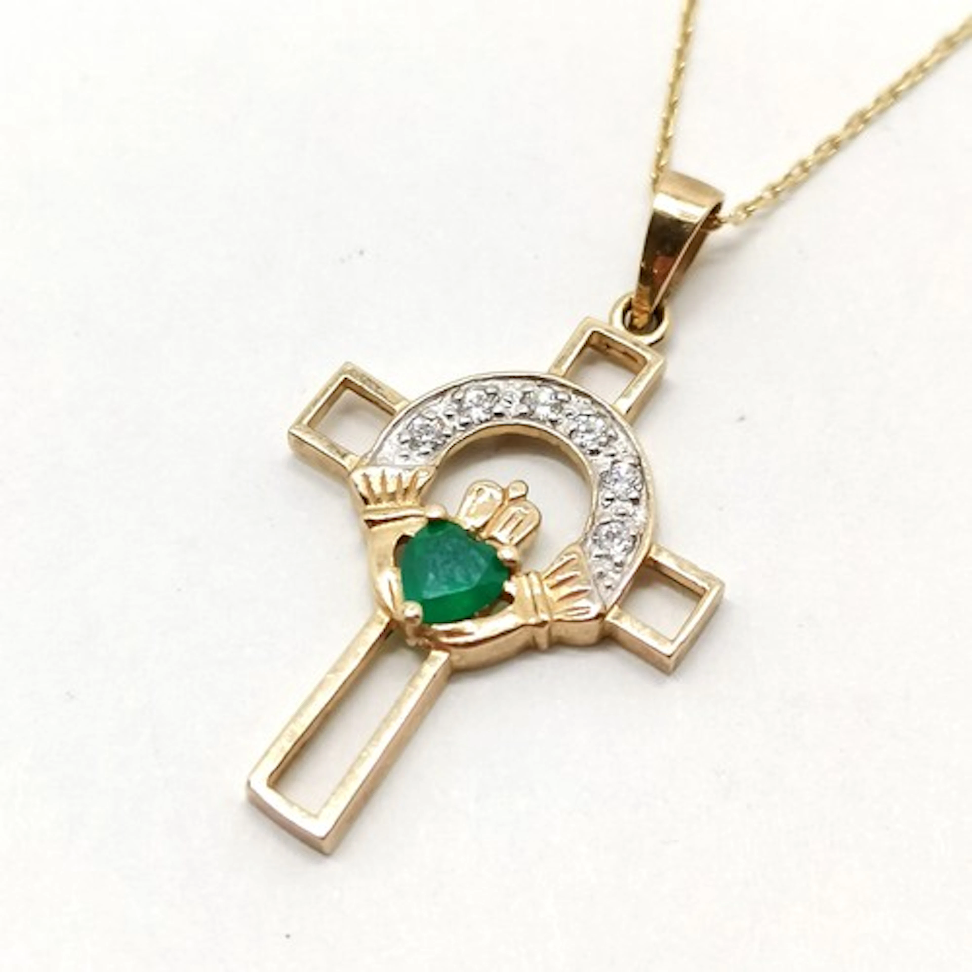 Unmarked gold green & white stone set claddagh cross pendant...
