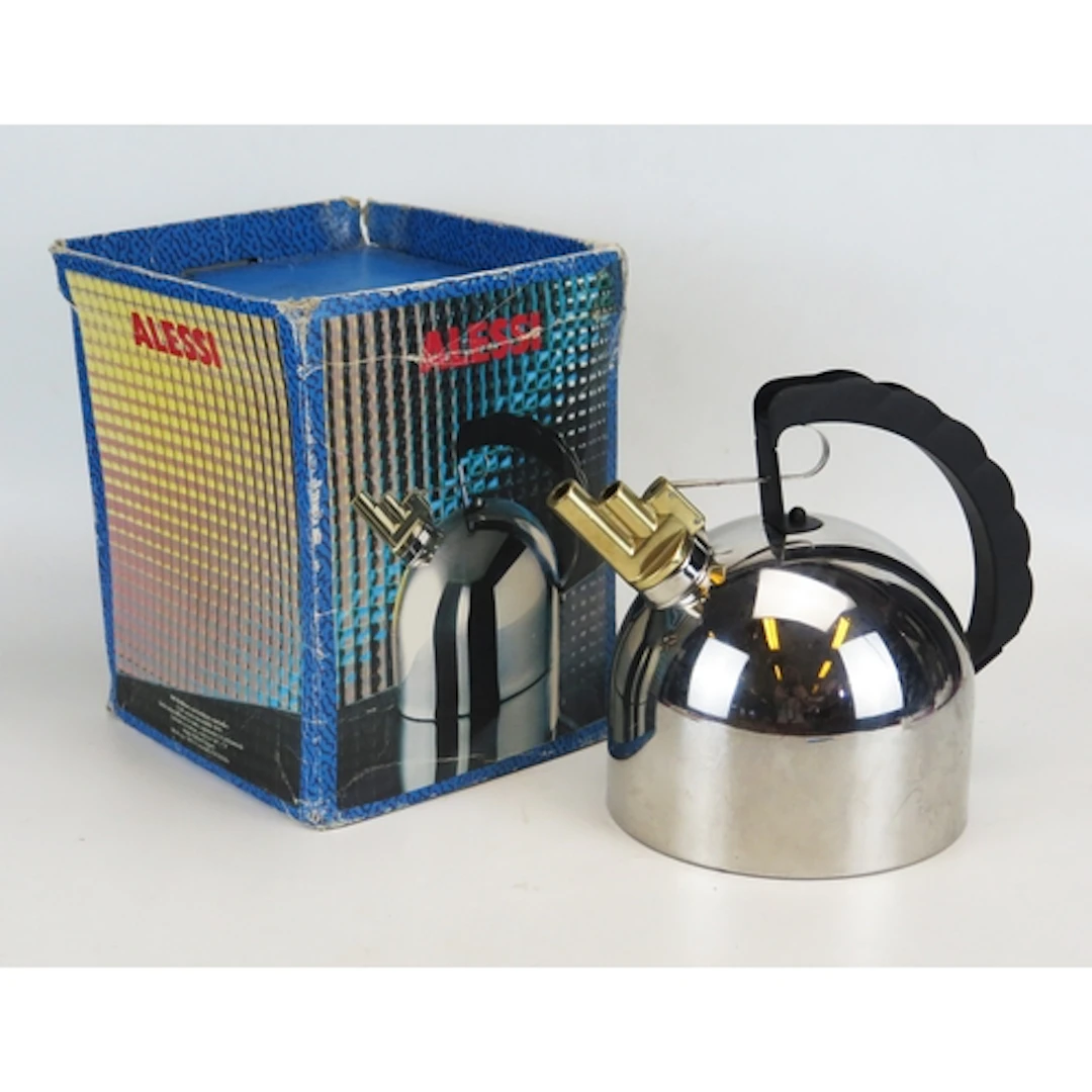 An Alessi stainless steel kettle with brass whistle and clou...