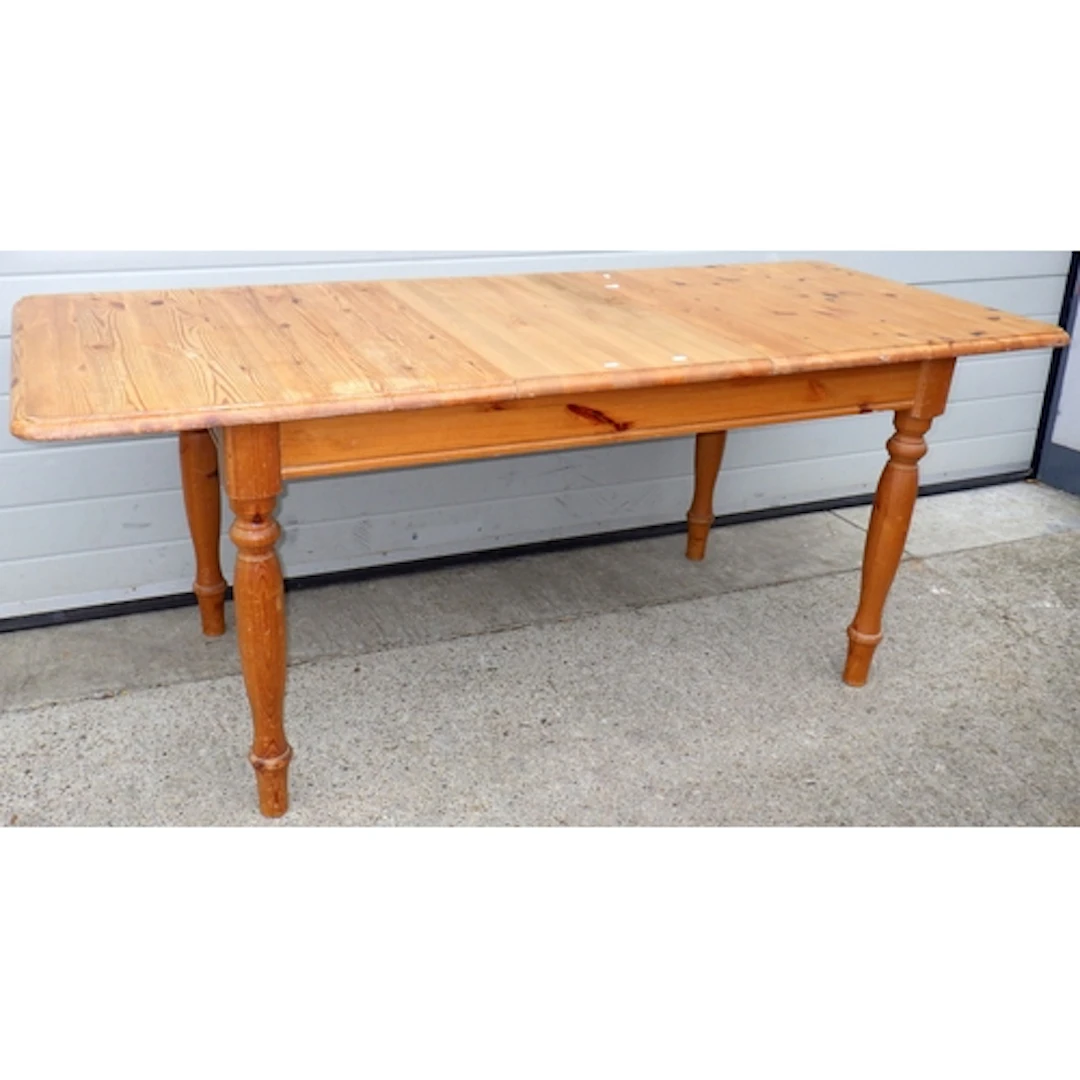 A modern pine extending dining table with one leaf, 145cm lo...