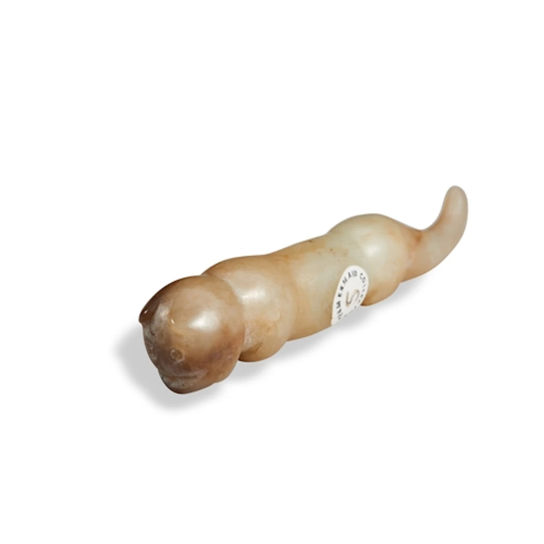 A YELLOW AND RUSSET JADE 'CAT' ORNAMENT MING DYNASTY OR EAR...