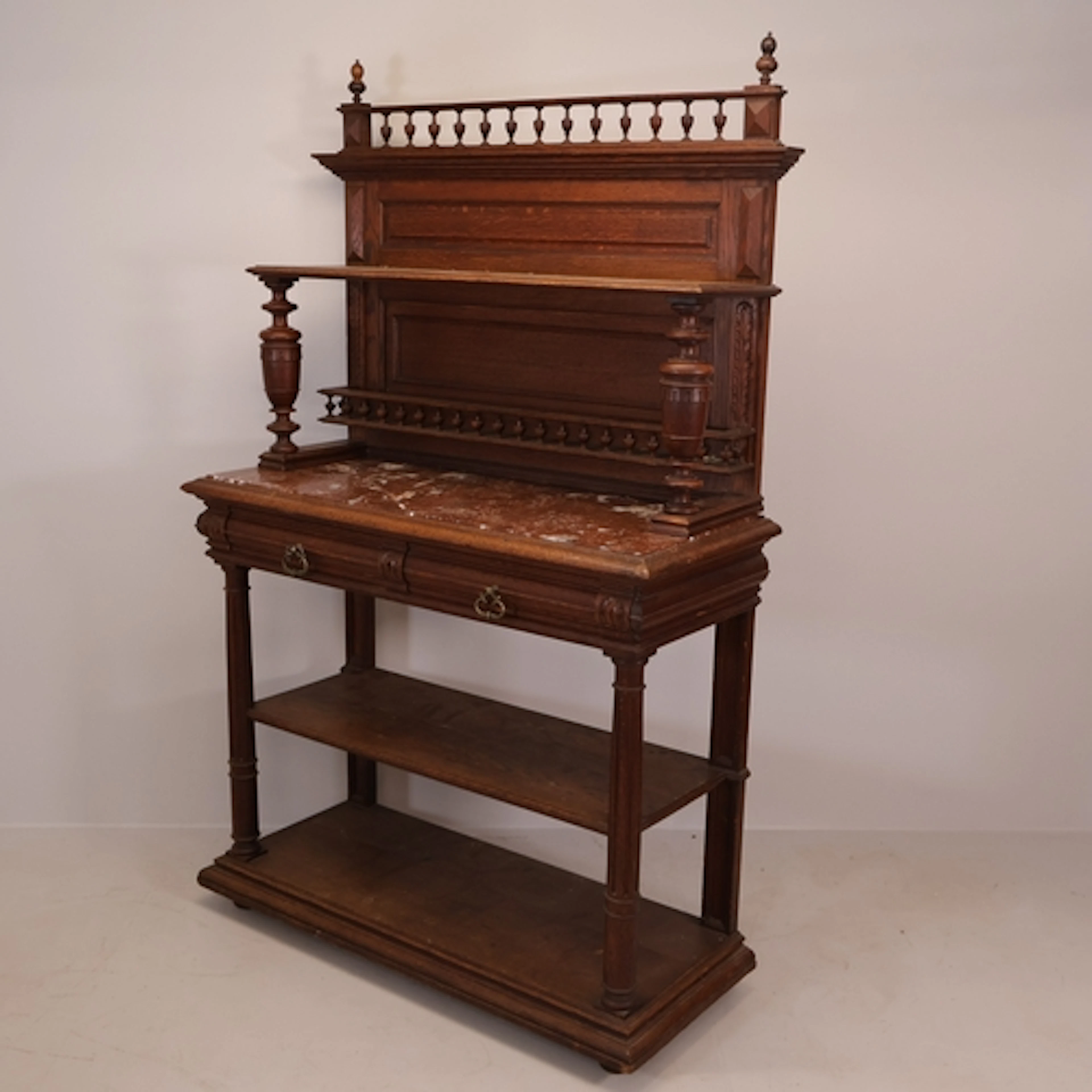 An antique French oak buffet, in two sections, with marble t...