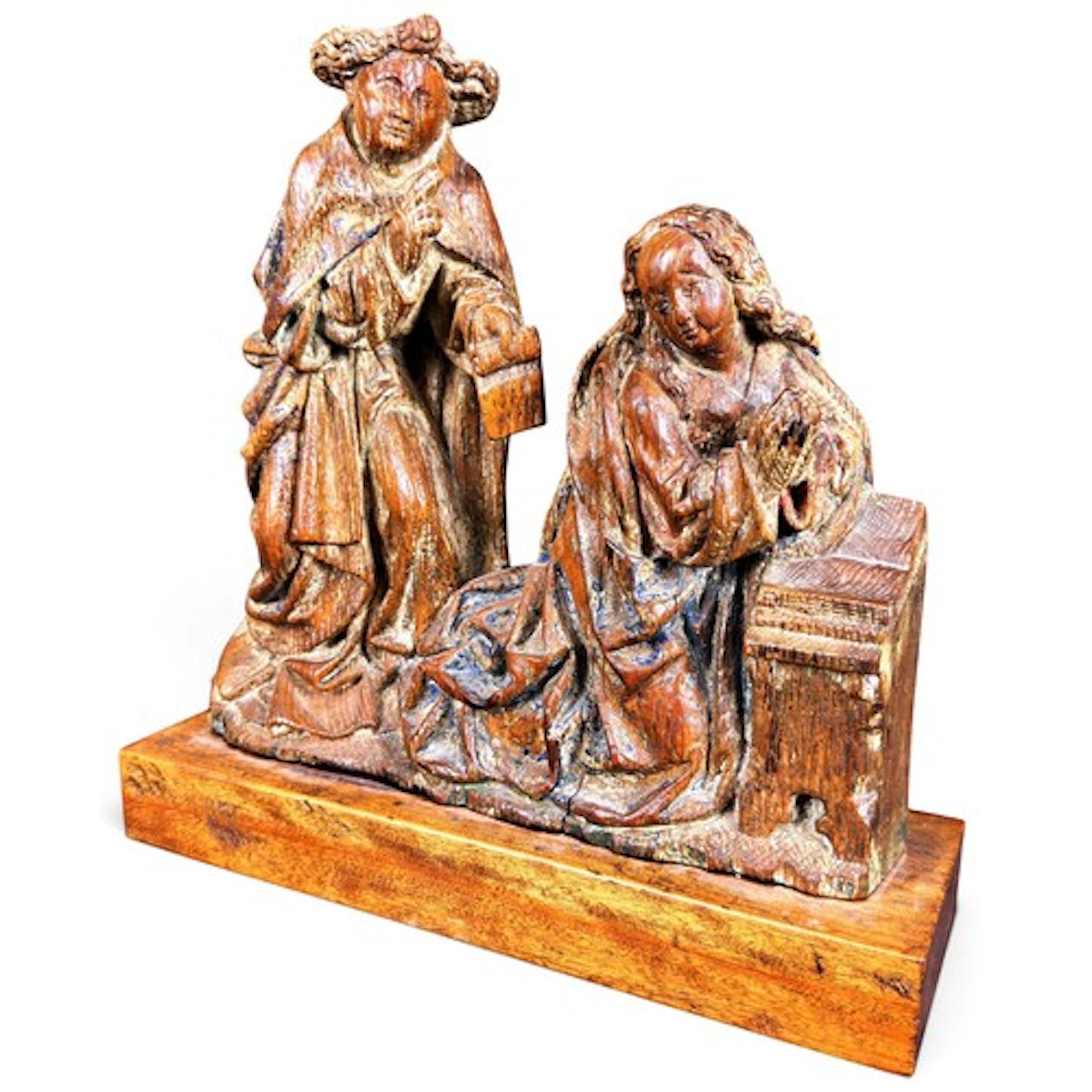 A carved oak relief of the Annunciation, carved in relief wi...