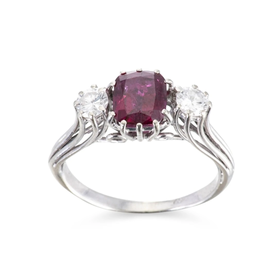 A GARNET AND DIAMOND THREE STONE RING, mounted in 18ct white...