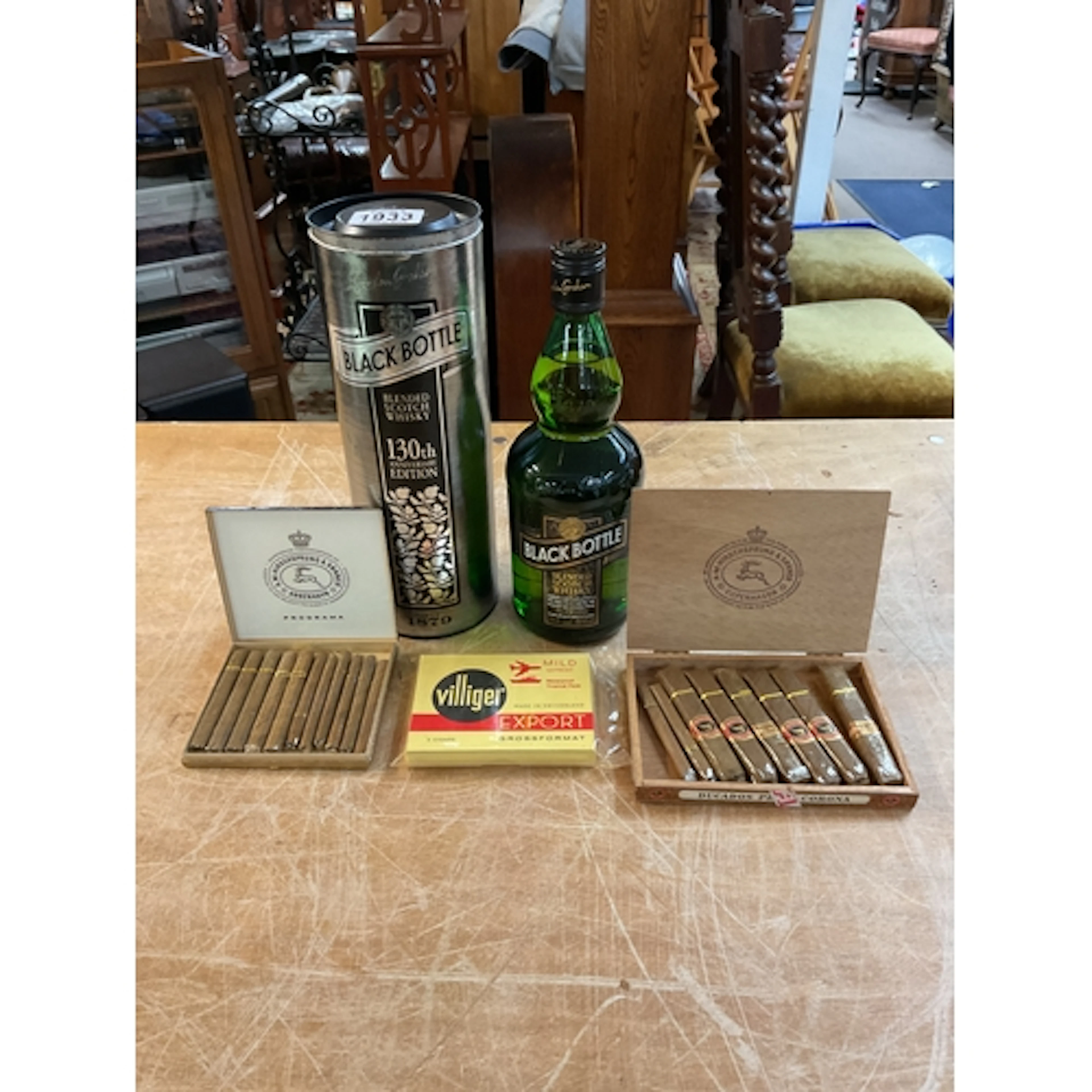 Black Bottle Whisky and three boxes of cigars.