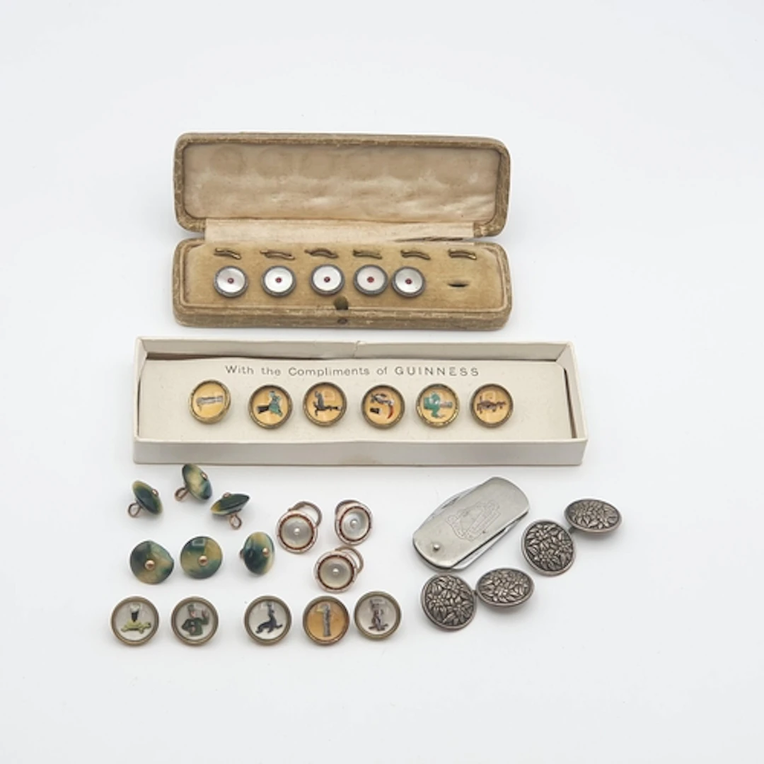 A boxed set of six Guinness buttons, a further part set of f...