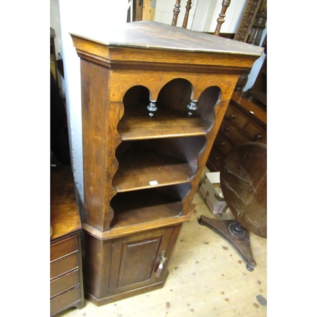 Oak standing corner cabinet, with open shelves above a field...