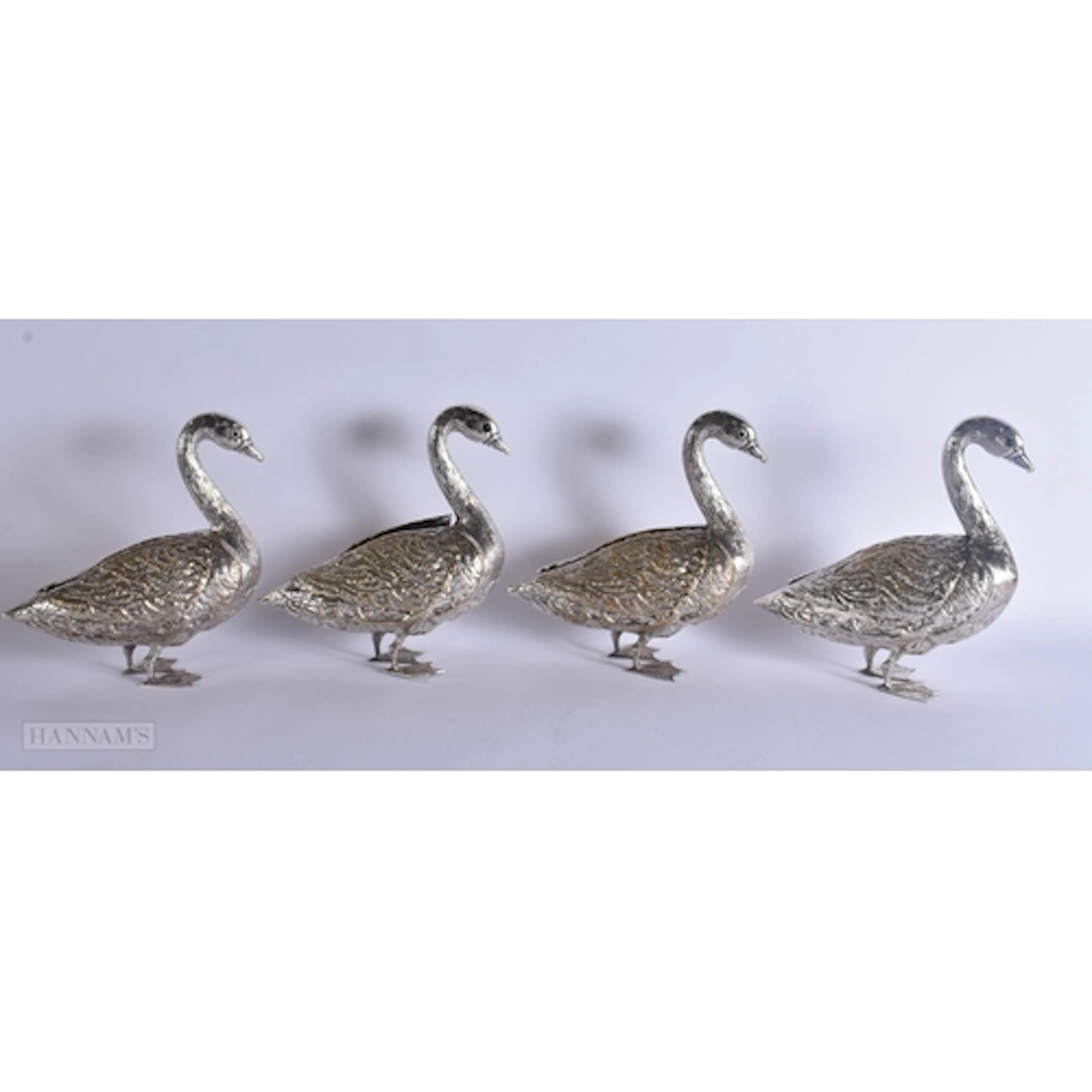 A SET OF FOUR SILVER PLATED FIGURES OF DUCKS with folding we...