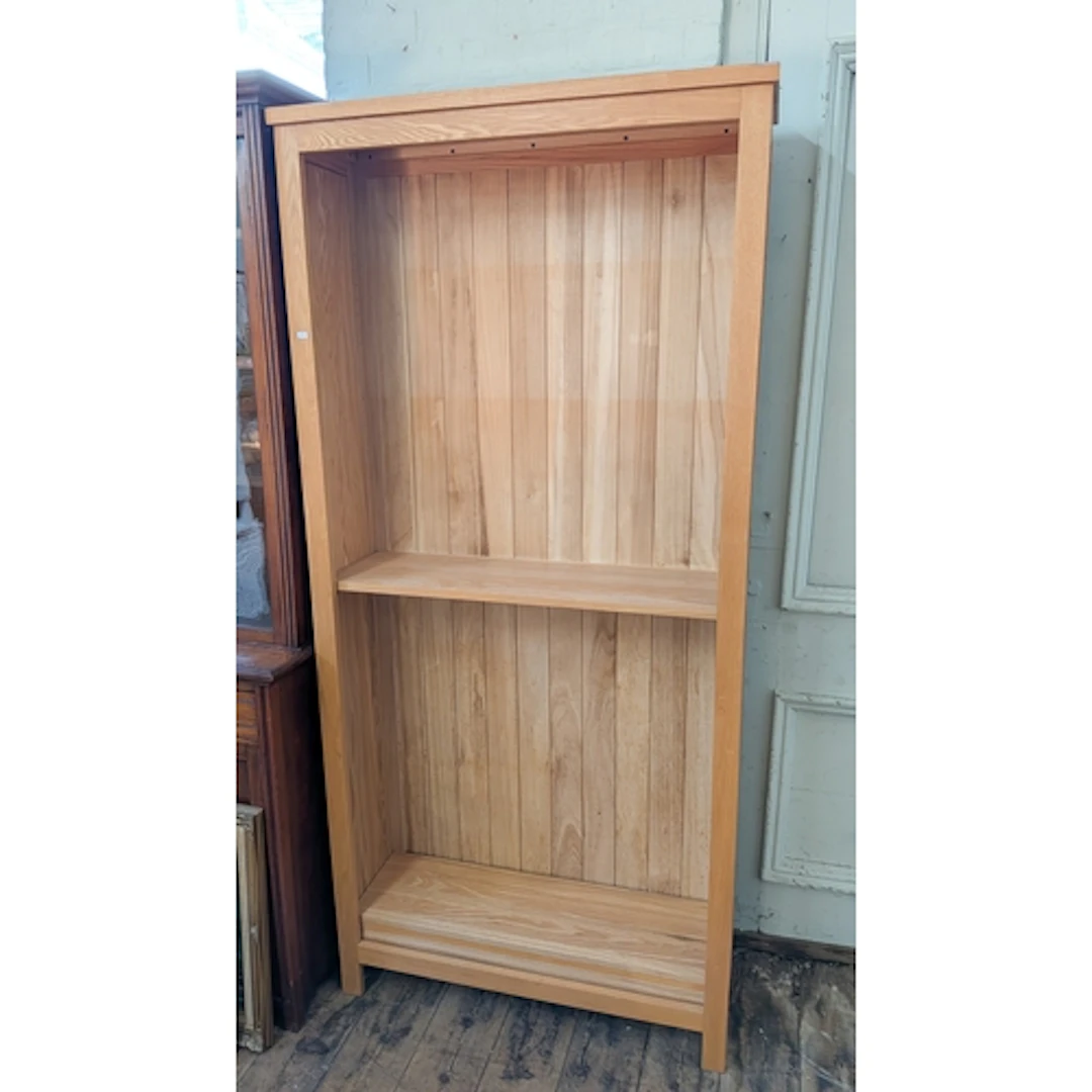 A modern light oak open bookcase with adjustable shelves