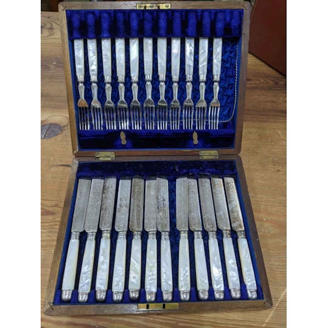 A mahogany cased set of fruit knives and forks with mother o...